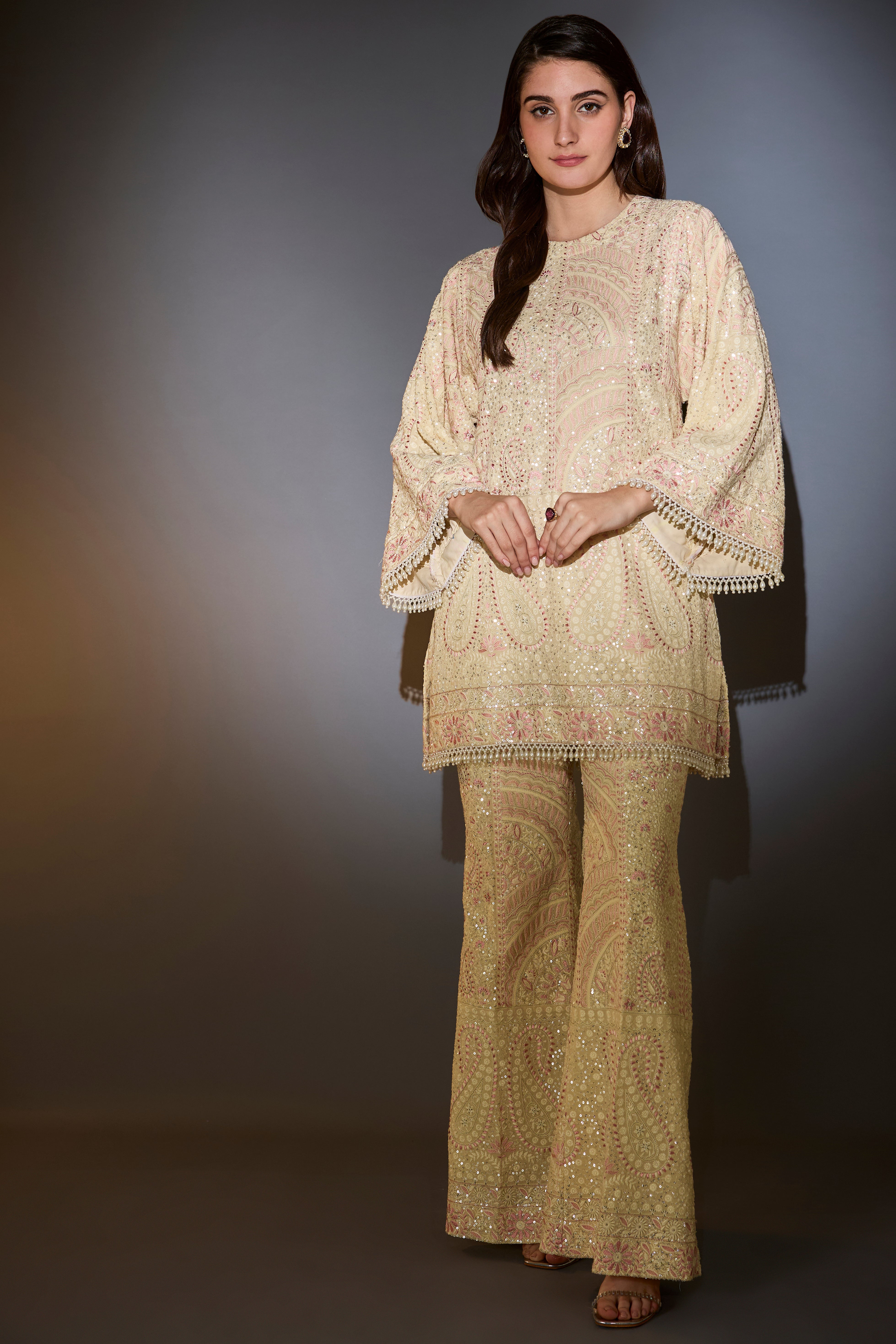 Cream chikankari co-ord set with intricate pink thread work and sequin embroidery.