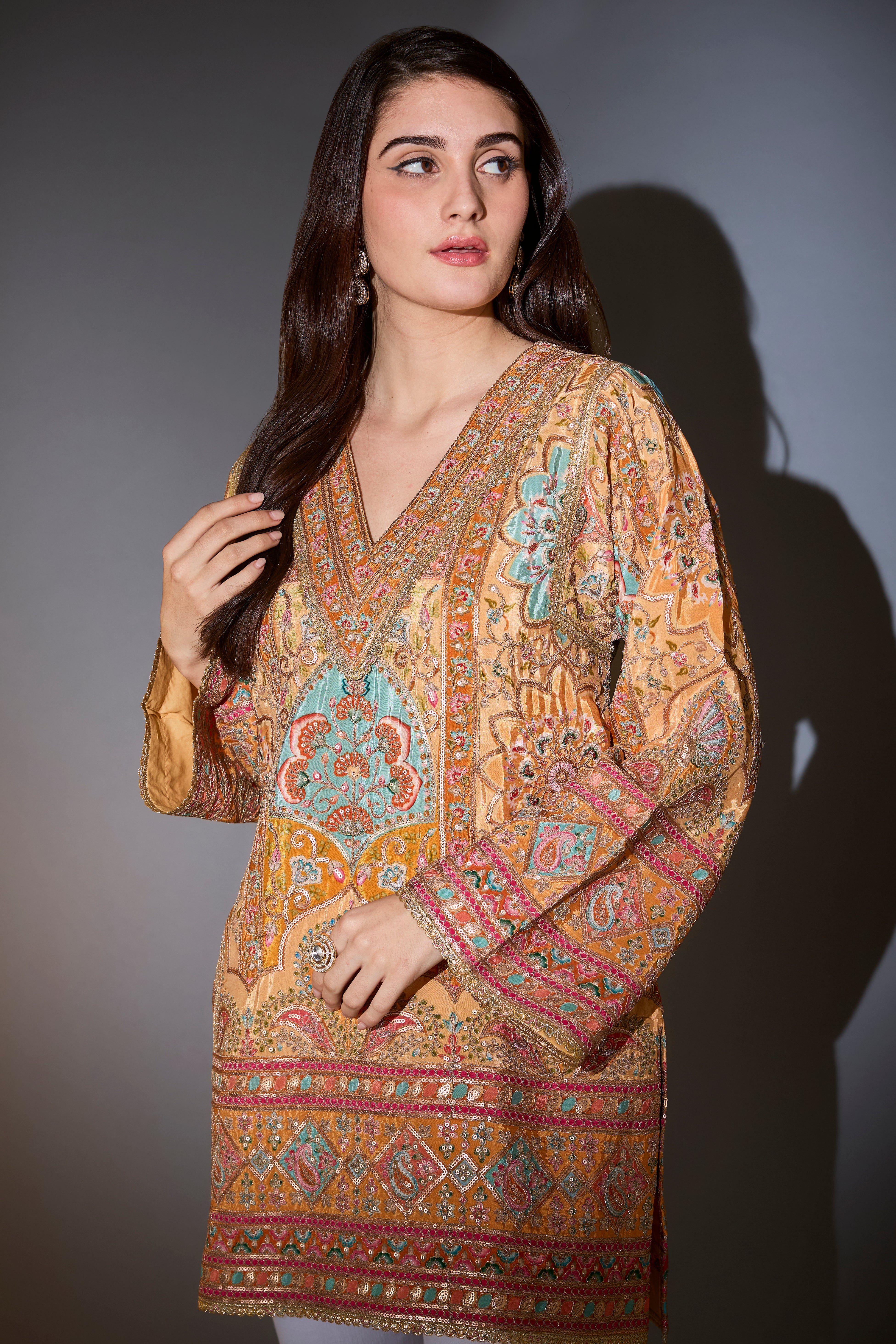 Mustard tunic with intricate multi-thread and aari work.