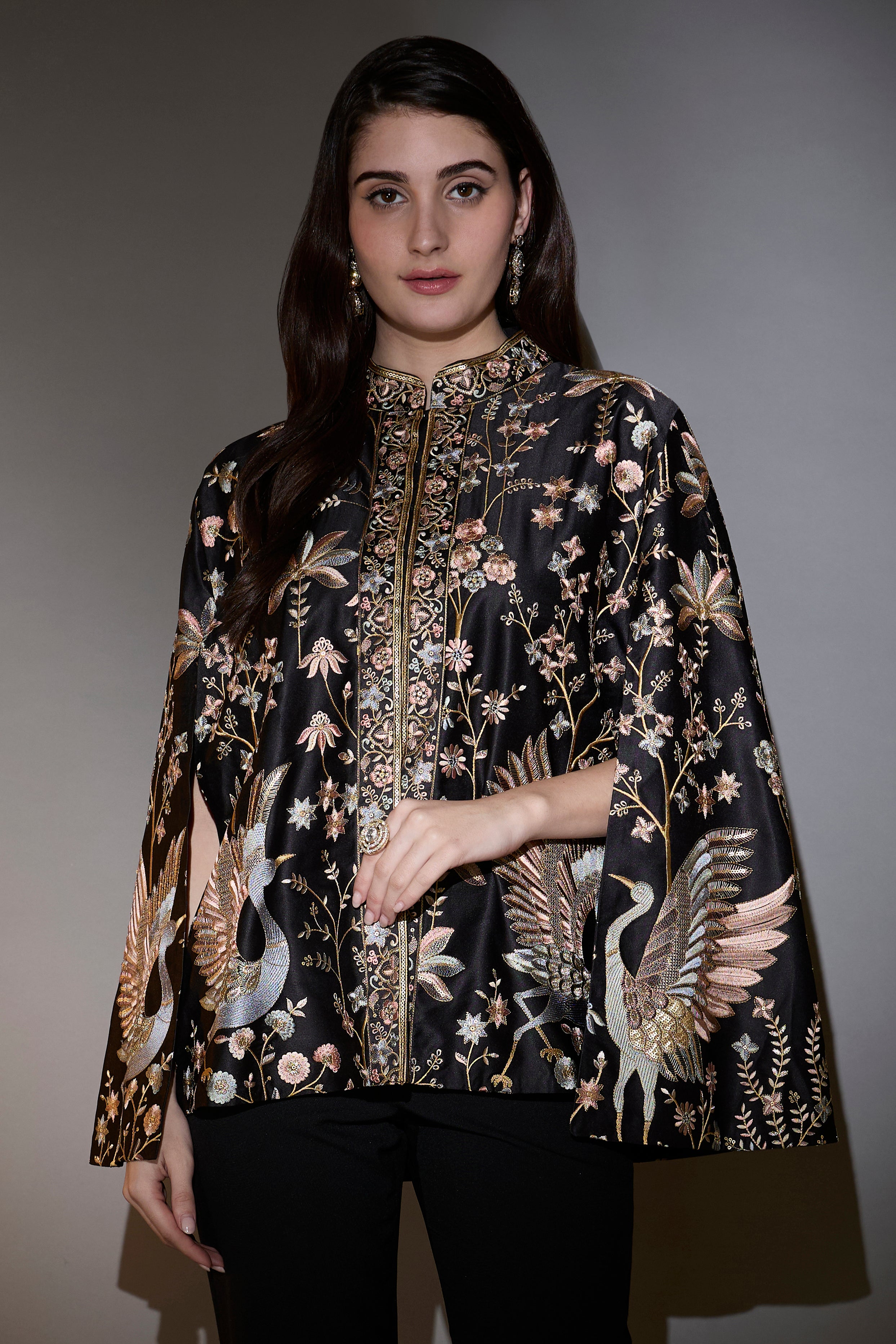 Black cape with intricate multi-thread work, elevated by swan motifs.