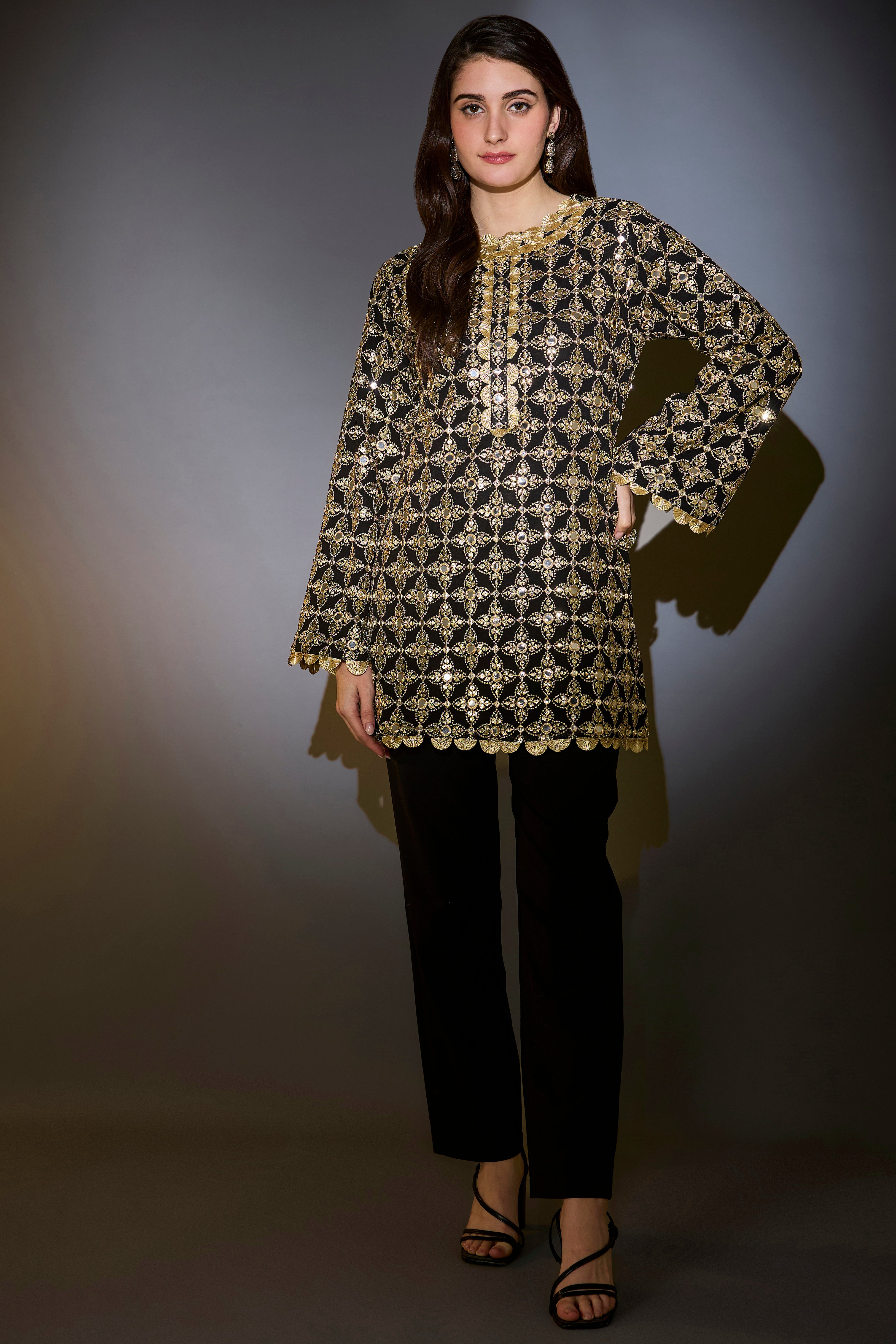 Heavy black tunic with intricate mirror and zari work, with detailed gota edgings.