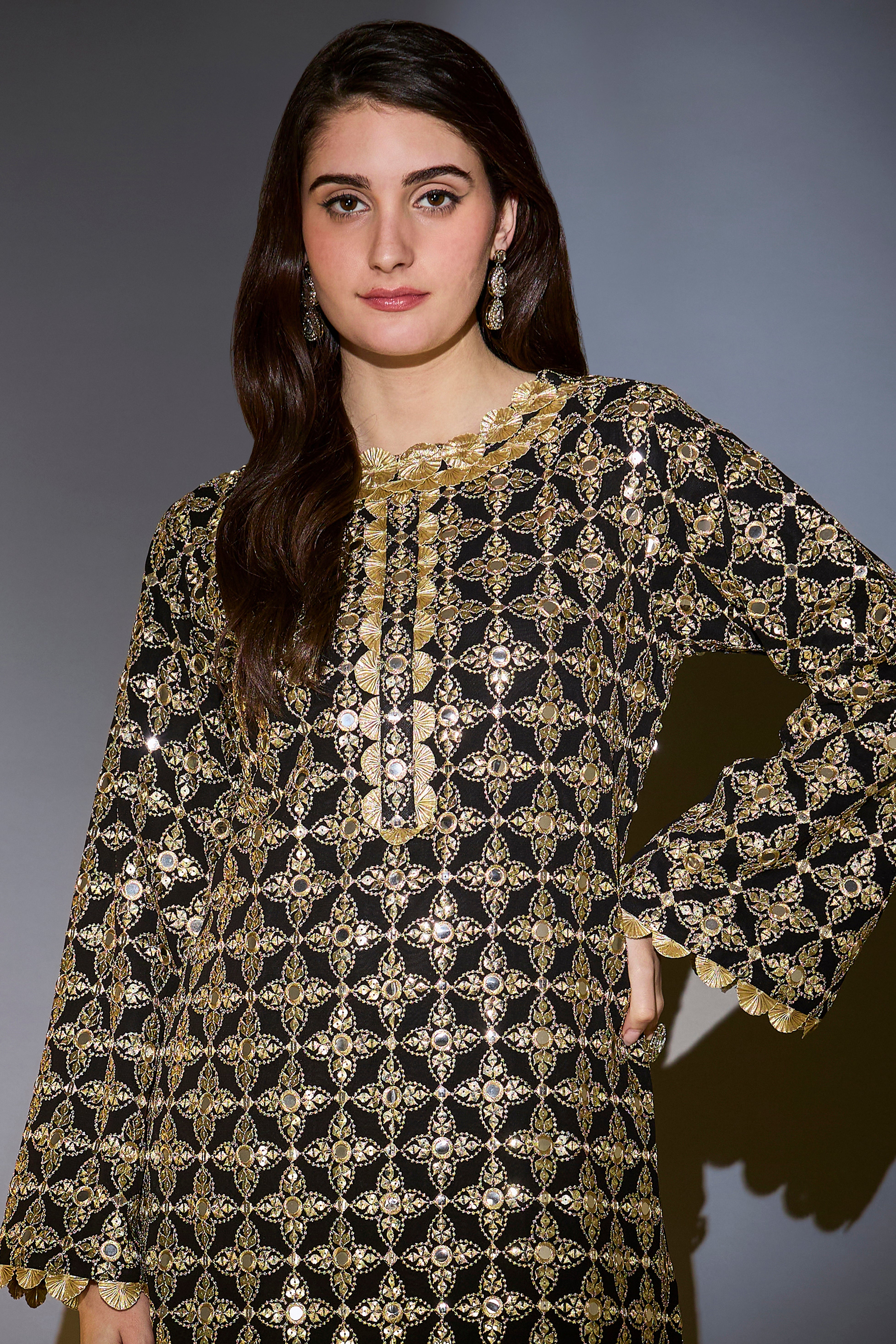 Heavy black tunic with intricate mirror and zari work, with detailed gota edgings.