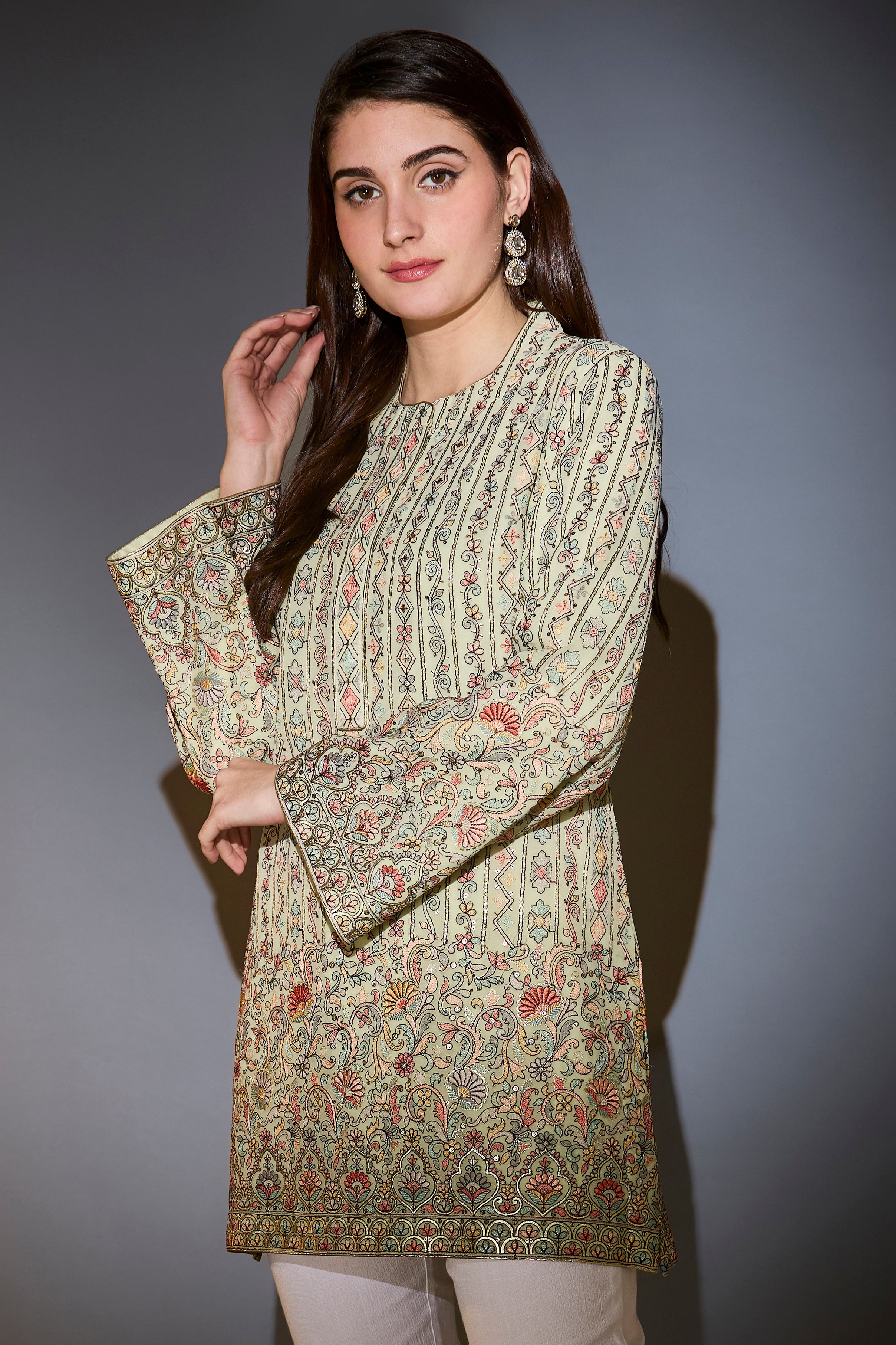 Mint green tunic with multi-thread embroidery.