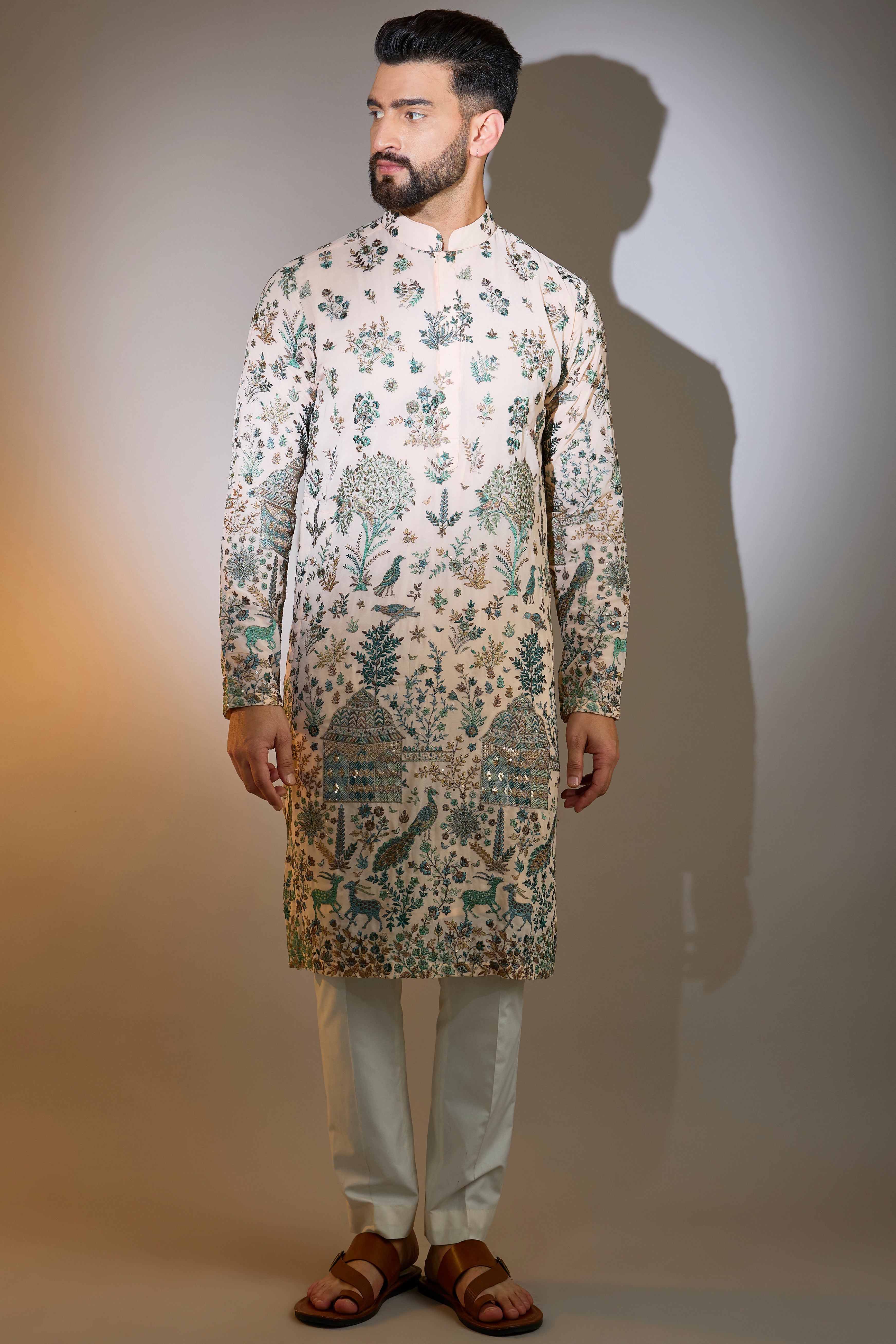 peach threadwork kurta with intricate flora and fauna motifs