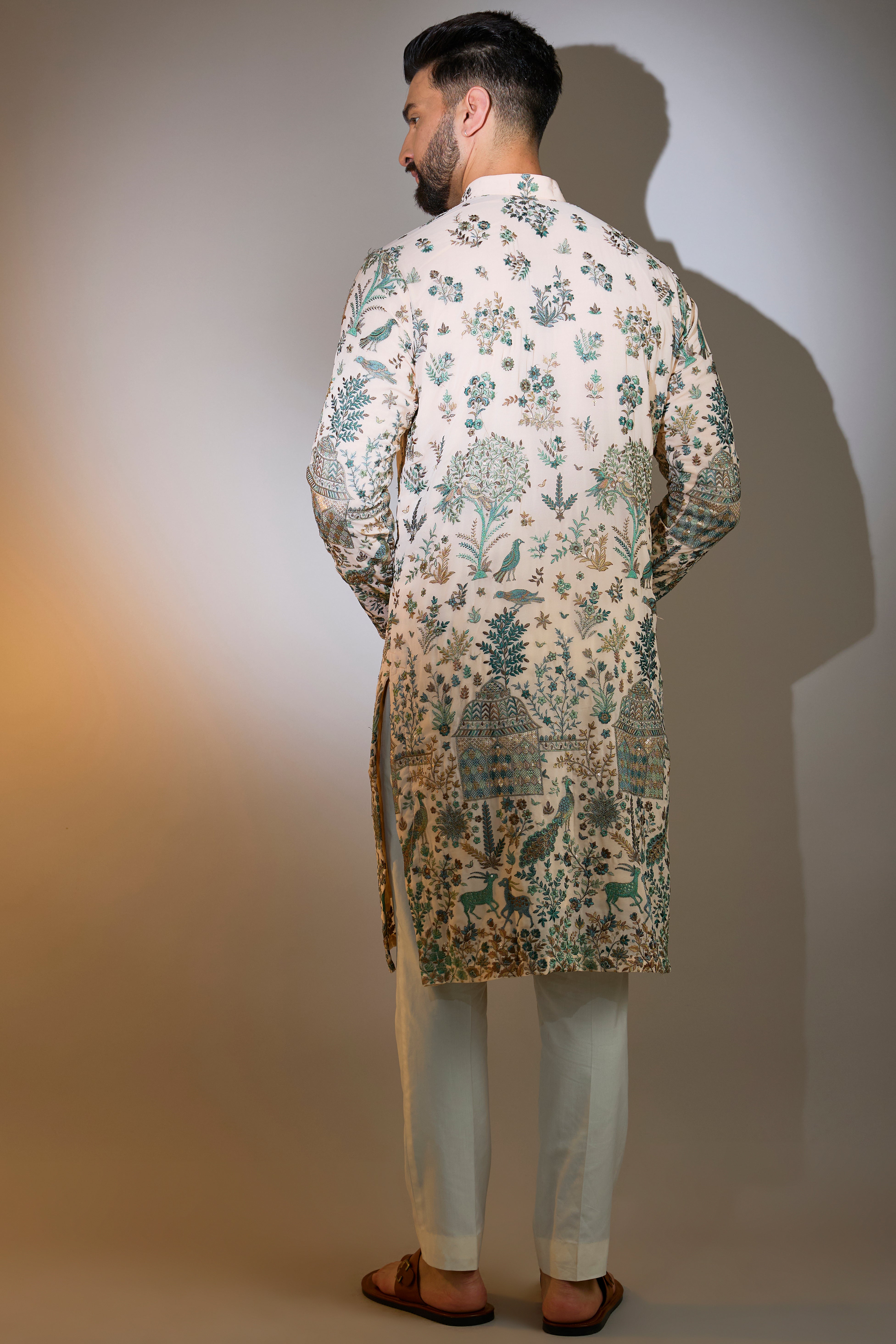 peach threadwork kurta with intricate flora and fauna motifs