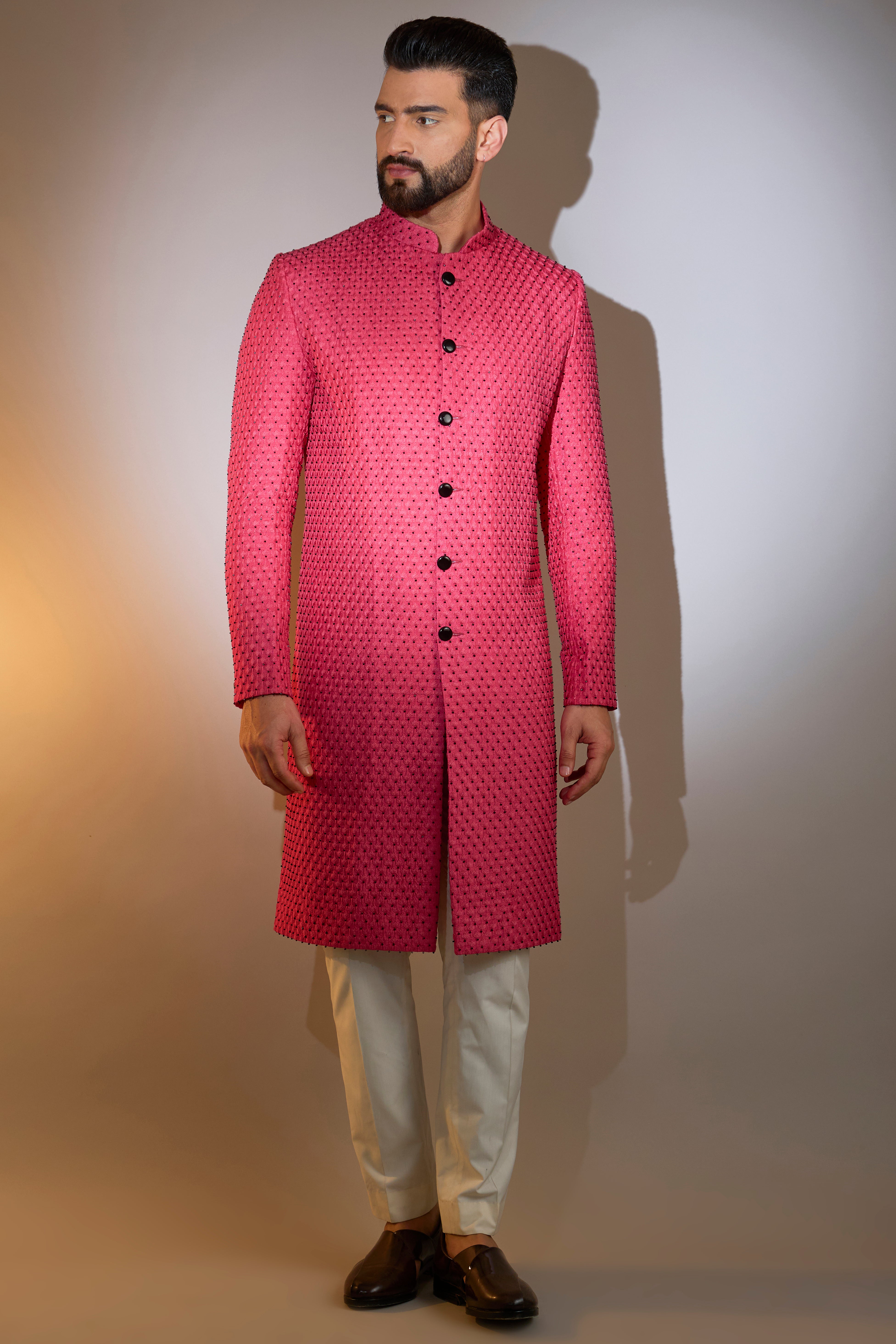 hot pink sherwani with intricate black cut dana work