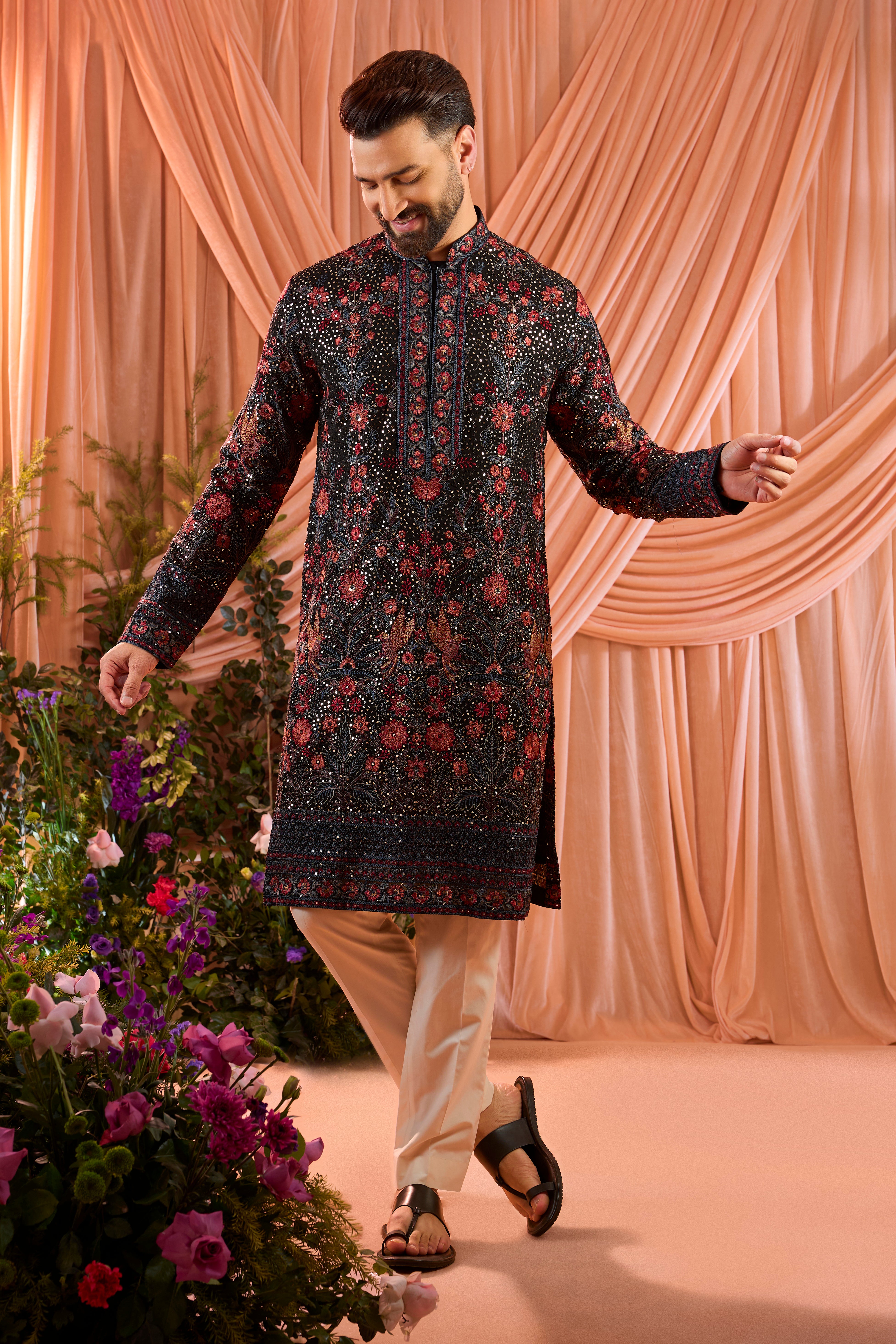 A black kurta elevated with heavy sequin work and intricate flora and fauna embroidery throughout.