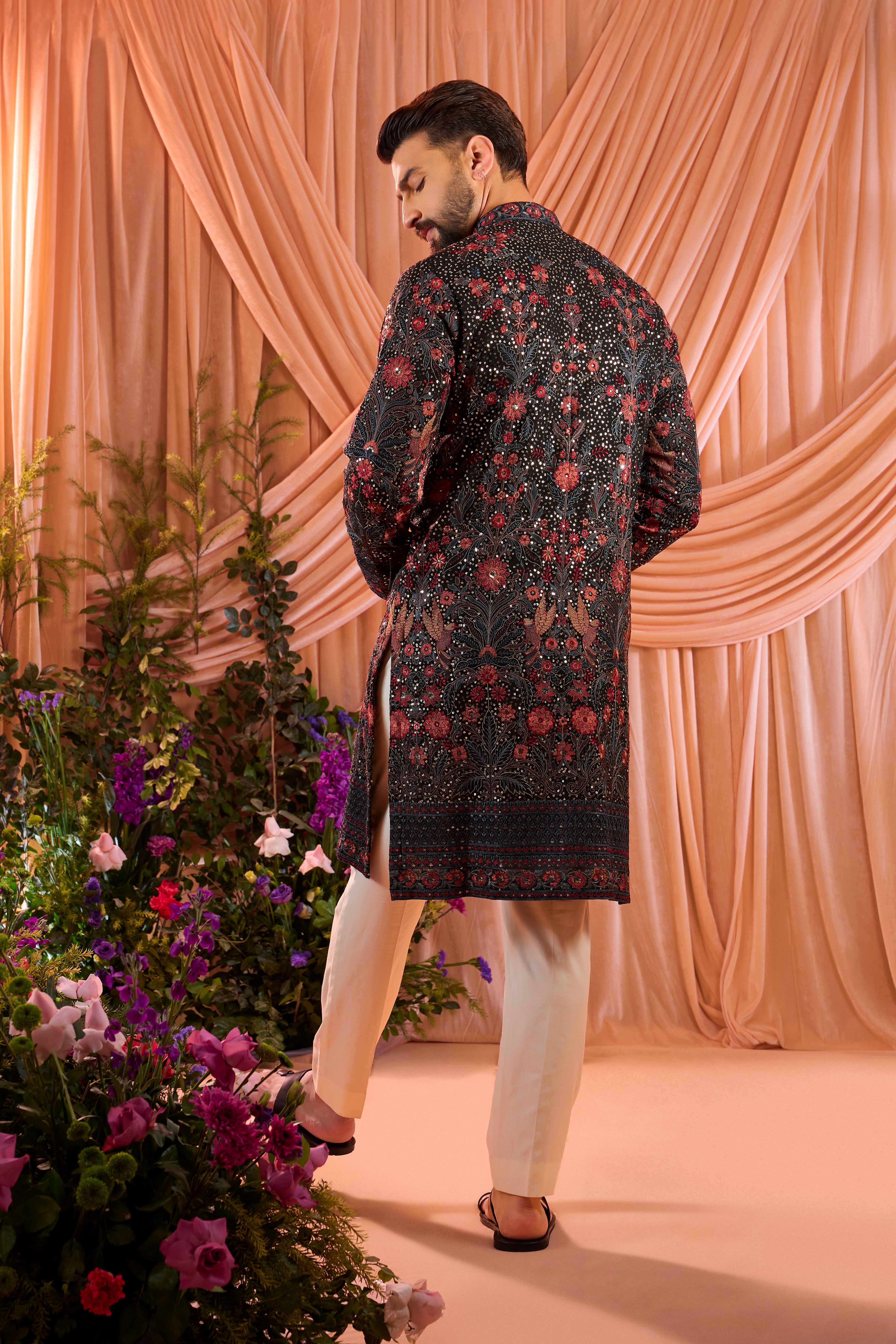 A black kurta elevated with heavy sequin work and intricate flora and fauna embroidery throughout.