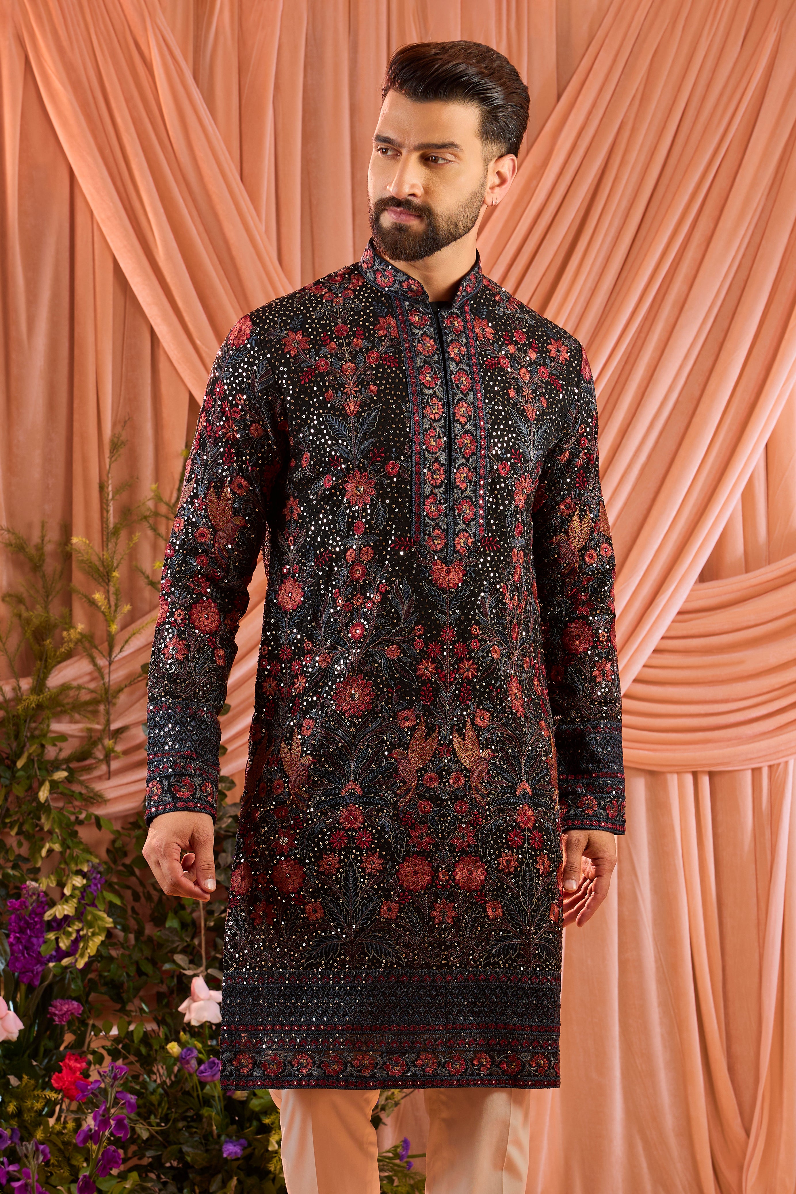 A black kurta elevated with heavy sequin work and intricate flora and fauna embroidery throughout.