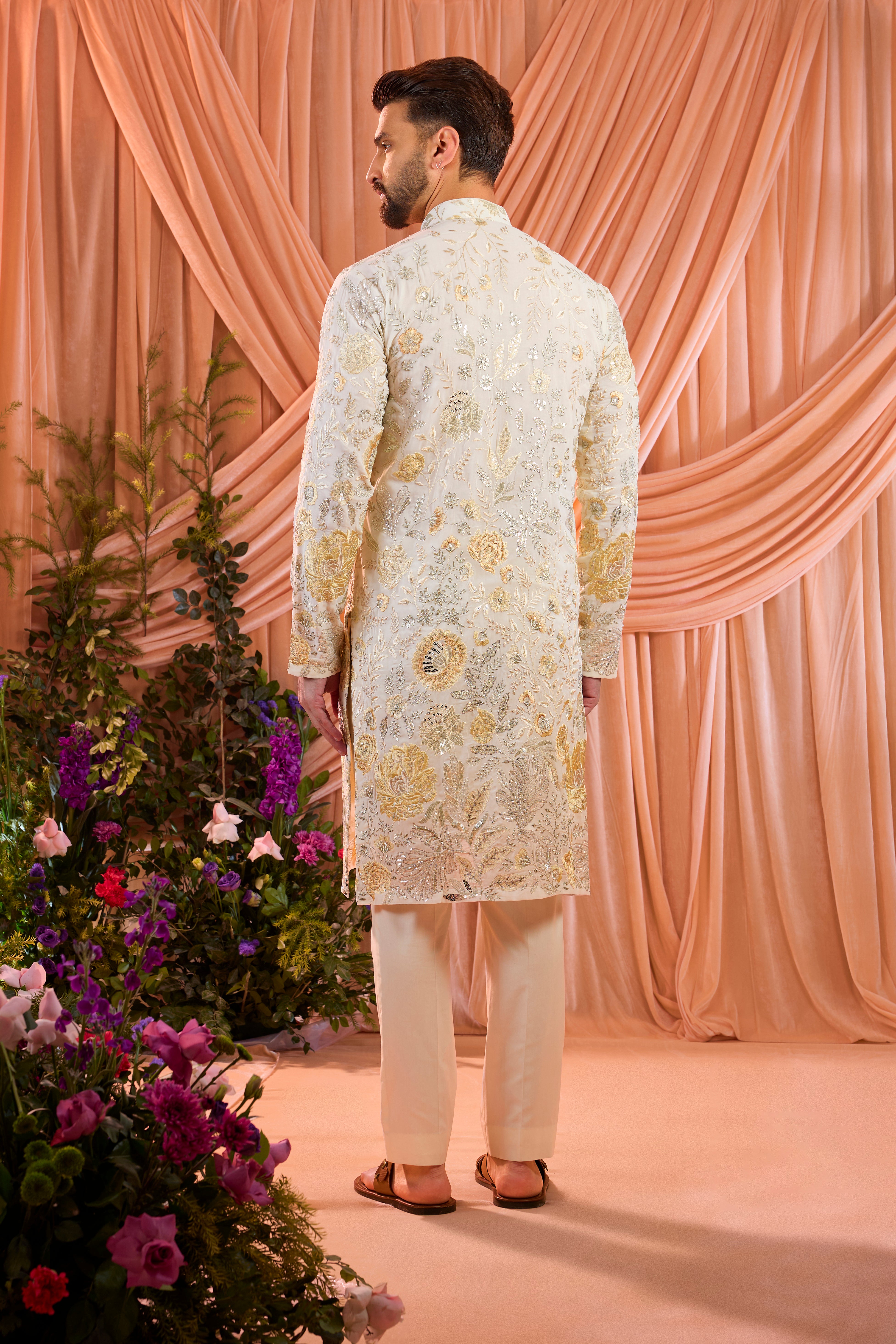 White  floral  kurta adorned with intricate multi-thread embroidery and subtle sequin highlights.