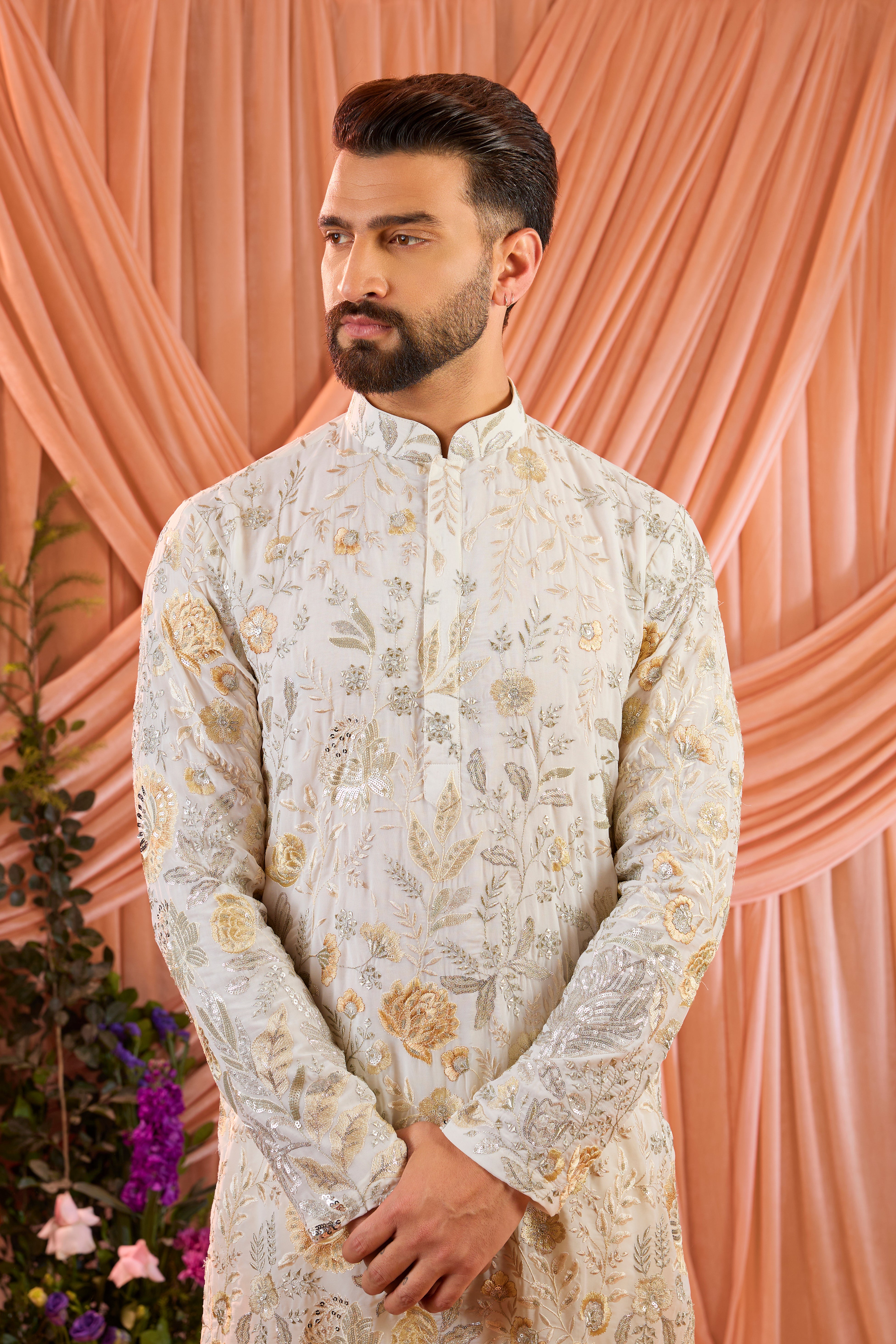 White  floral  kurta adorned with intricate multi-thread embroidery and subtle sequin highlights.