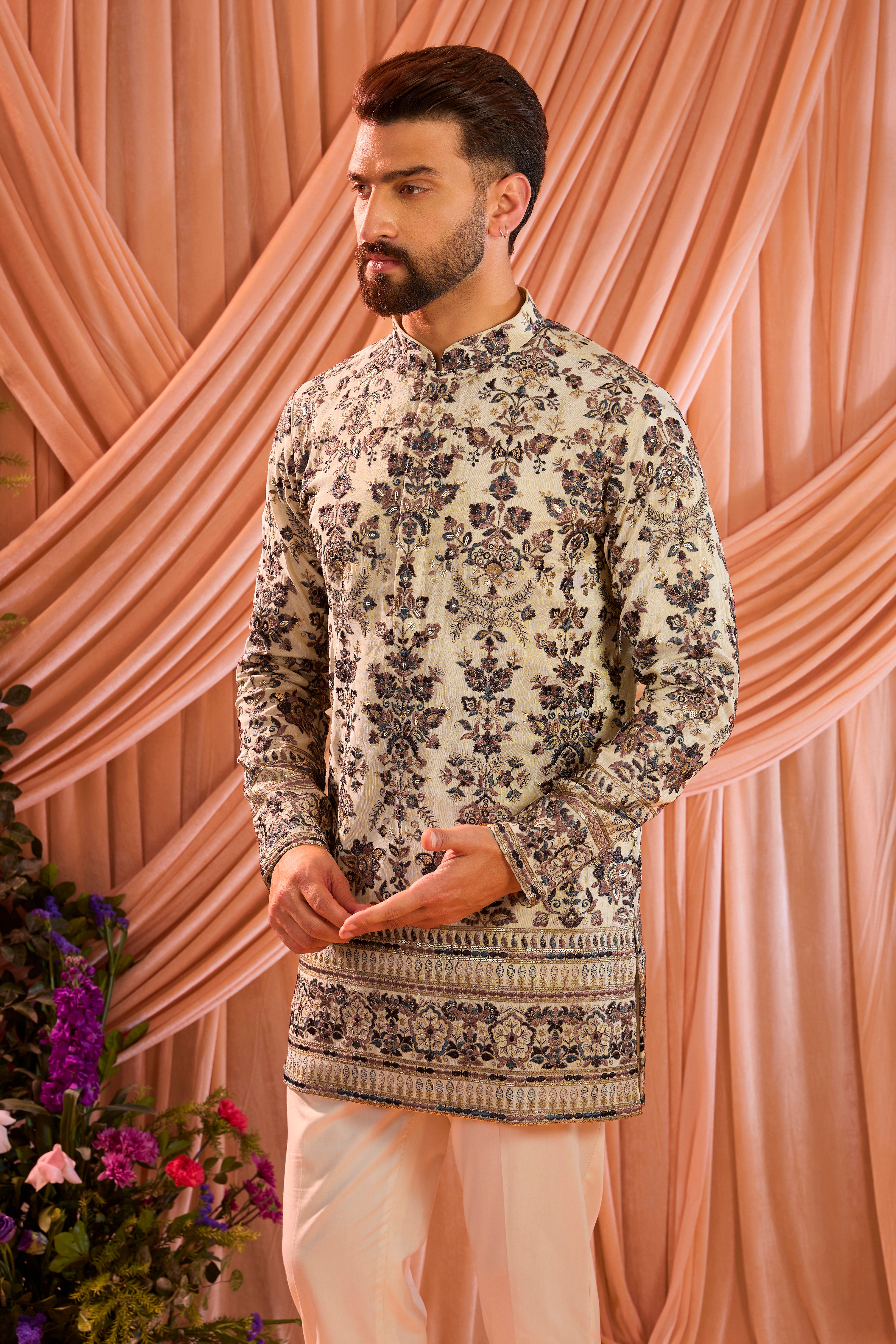 A light golden short floral chikankari kurta accented with delicate  multi threadwork, enriched by zari and subtle sequin detailing.