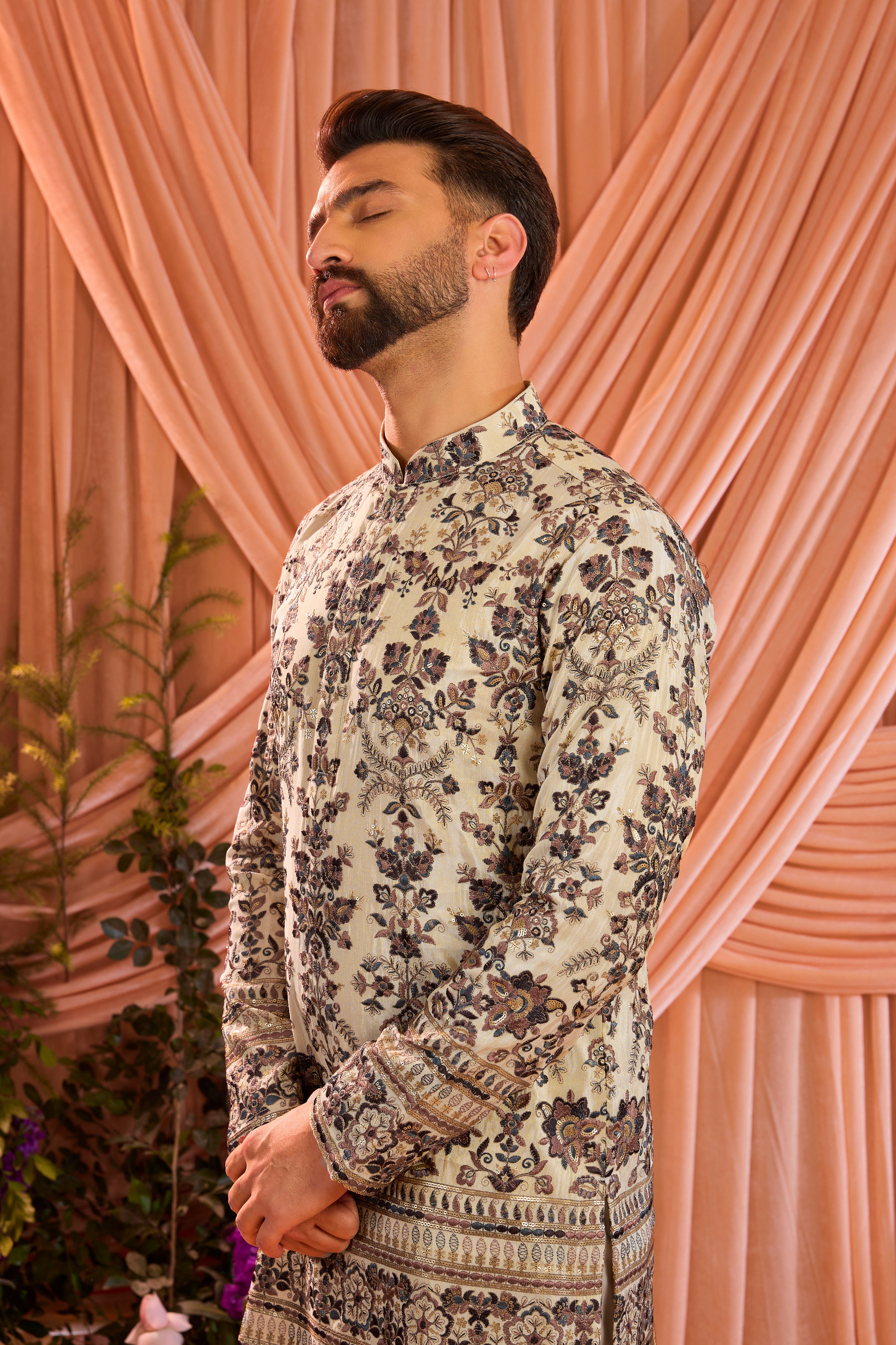 A light golden short floral chikankari kurta accented with delicate  multi threadwork, enriched by zari and subtle sequin detailing.