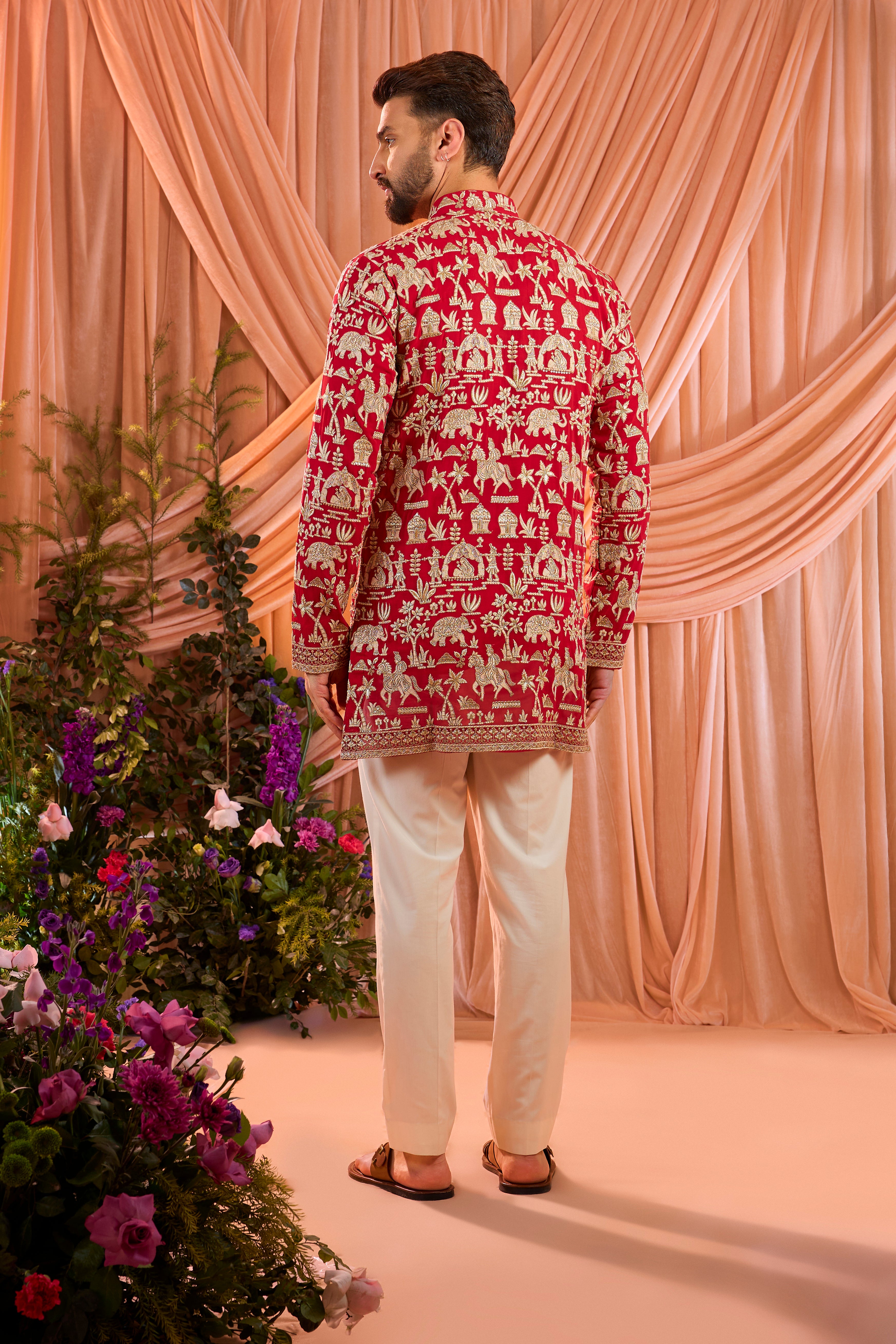 Hot pink royal-heritage kurta adorned with intricately detailed Mughal-era motifs, reflecting the grandeur of imperial artistry.