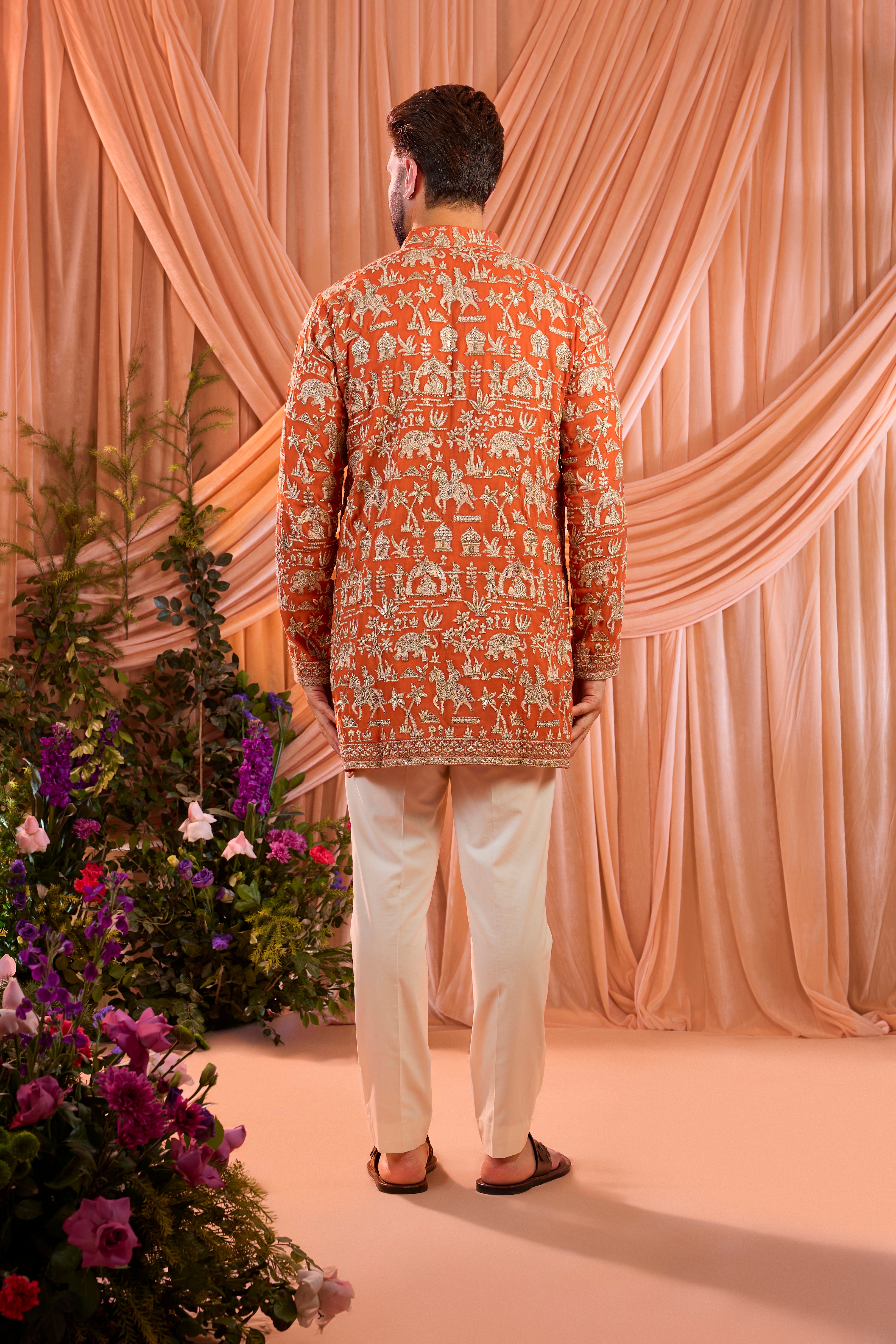 Orange pink royal-heritage kurta adorned with intricately detailed Mughal-era motifs, reflecting the grandeur of imperial artistry.