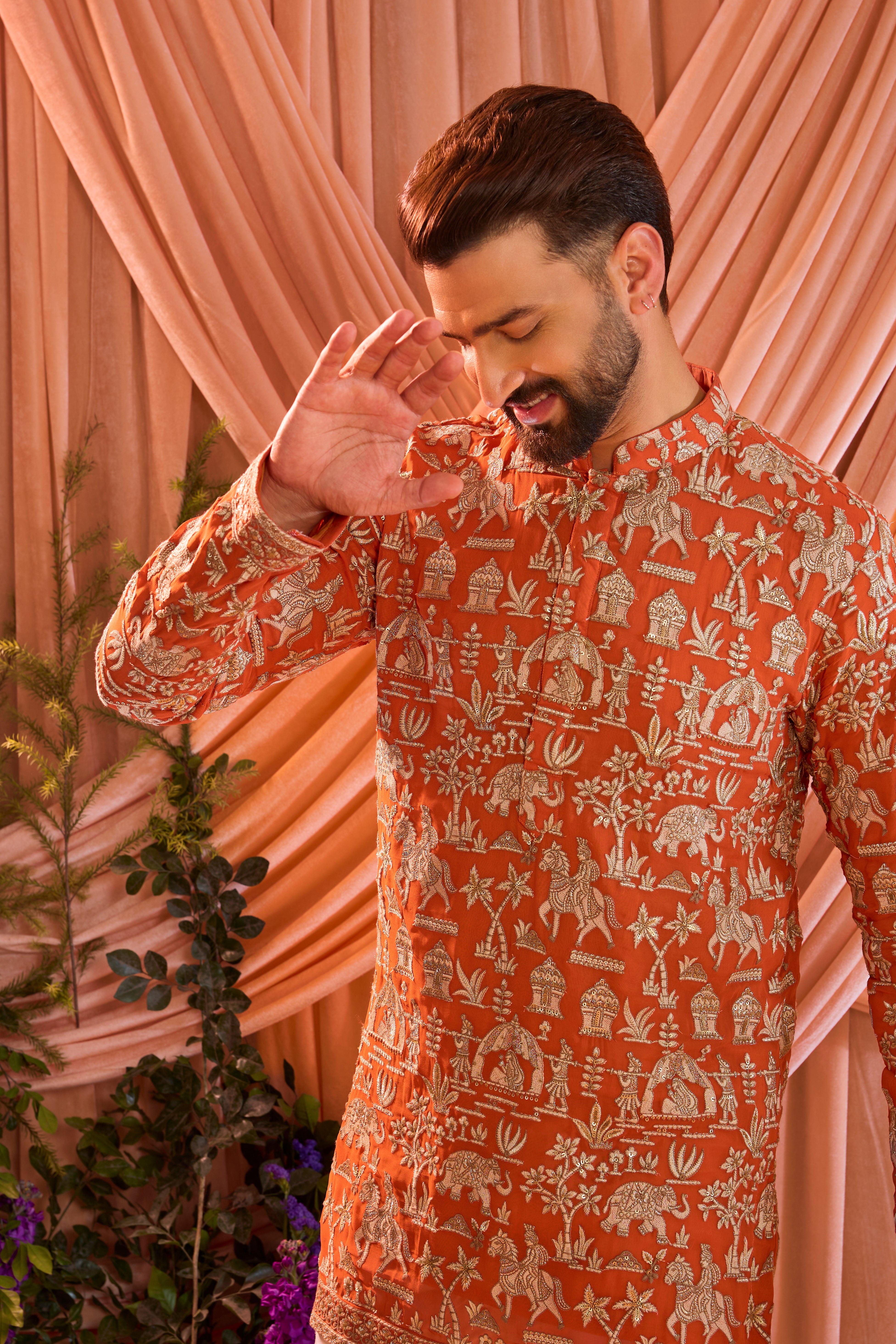 Orange pink royal-heritage kurta adorned with intricately detailed Mughal-era motifs, reflecting the grandeur of imperial artistry.
