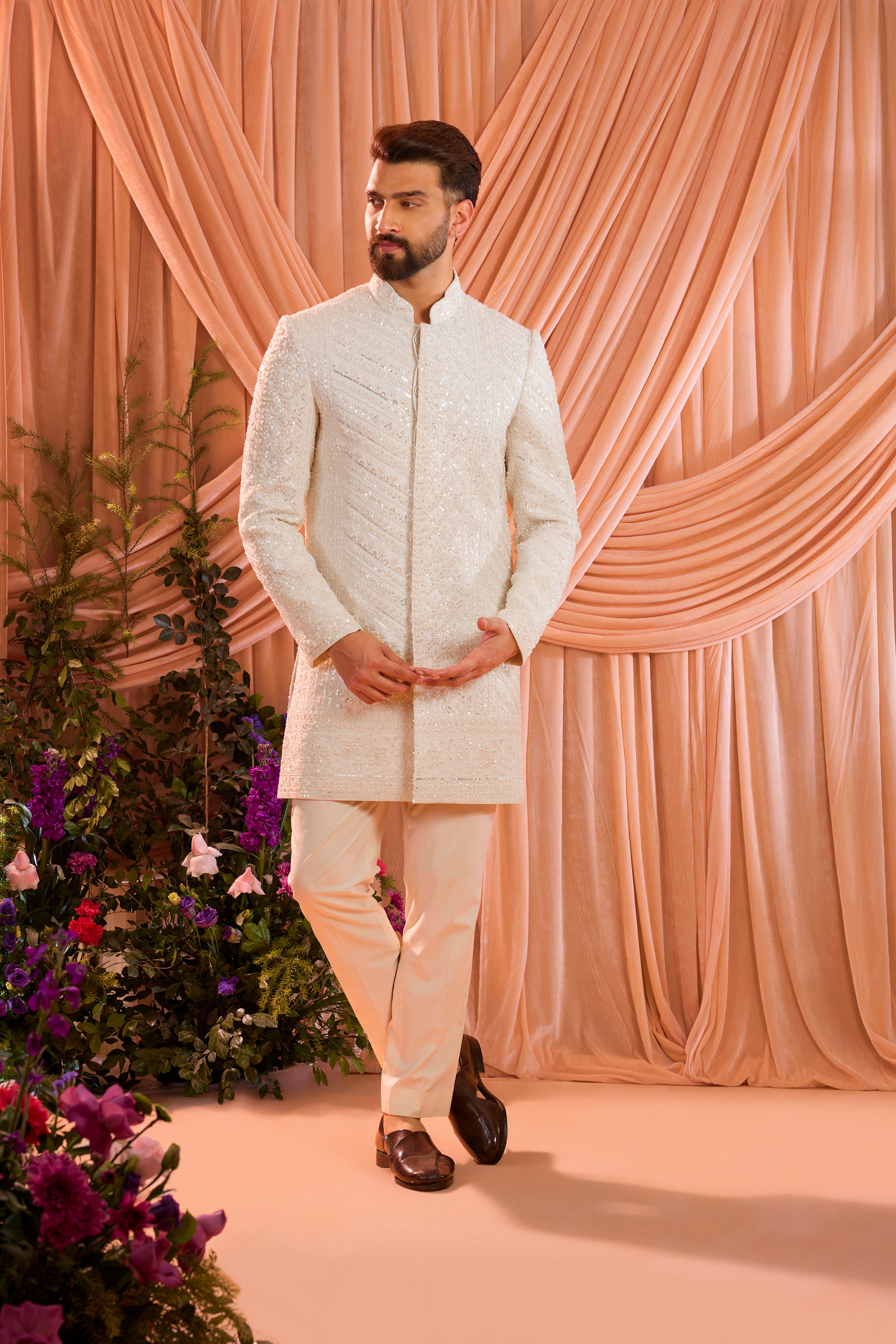 An ivory hand-embroidered formal short sherwani, exquisitely adorned with intricate ivory cut-dana detailing