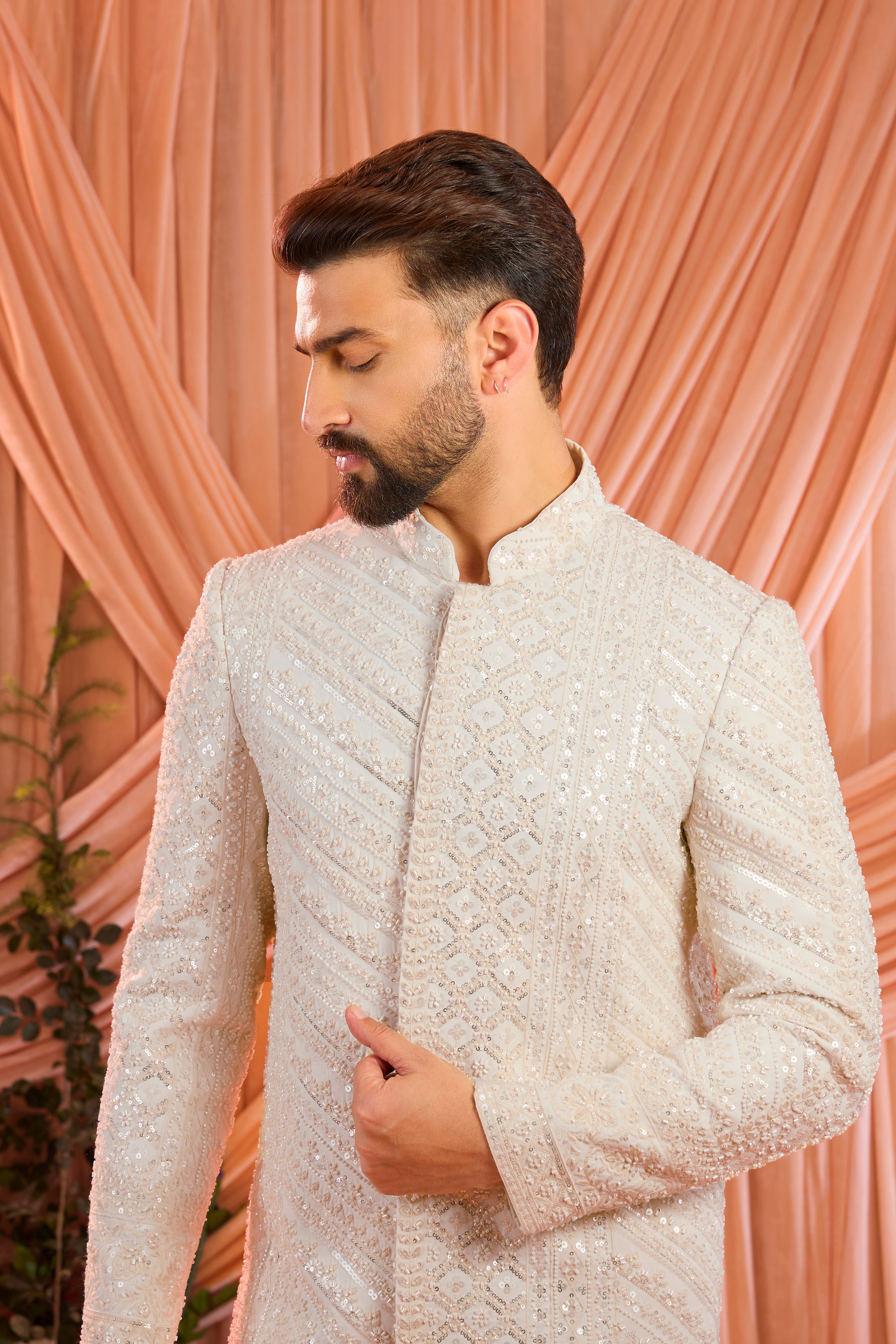 An ivory hand-embroidered formal short sherwani, exquisitely adorned with intricate ivory cut-dana detailing