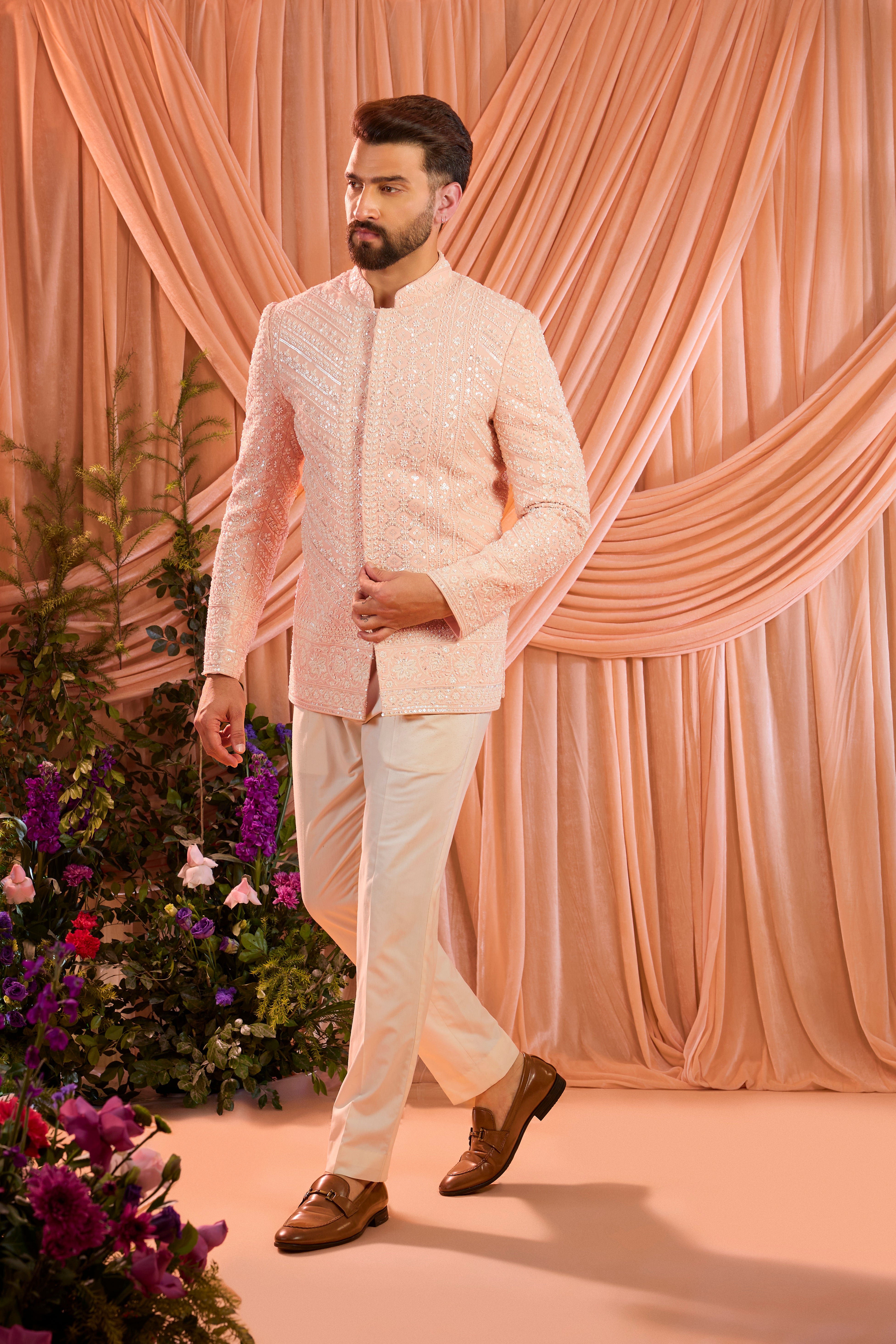 Pink  hand-embroidered formal jacket , exquisitely adorned with intricate ivory cut-dana detailing. The refined shimmer and precision craftsmanship evoke understated opulence and modern royalty.