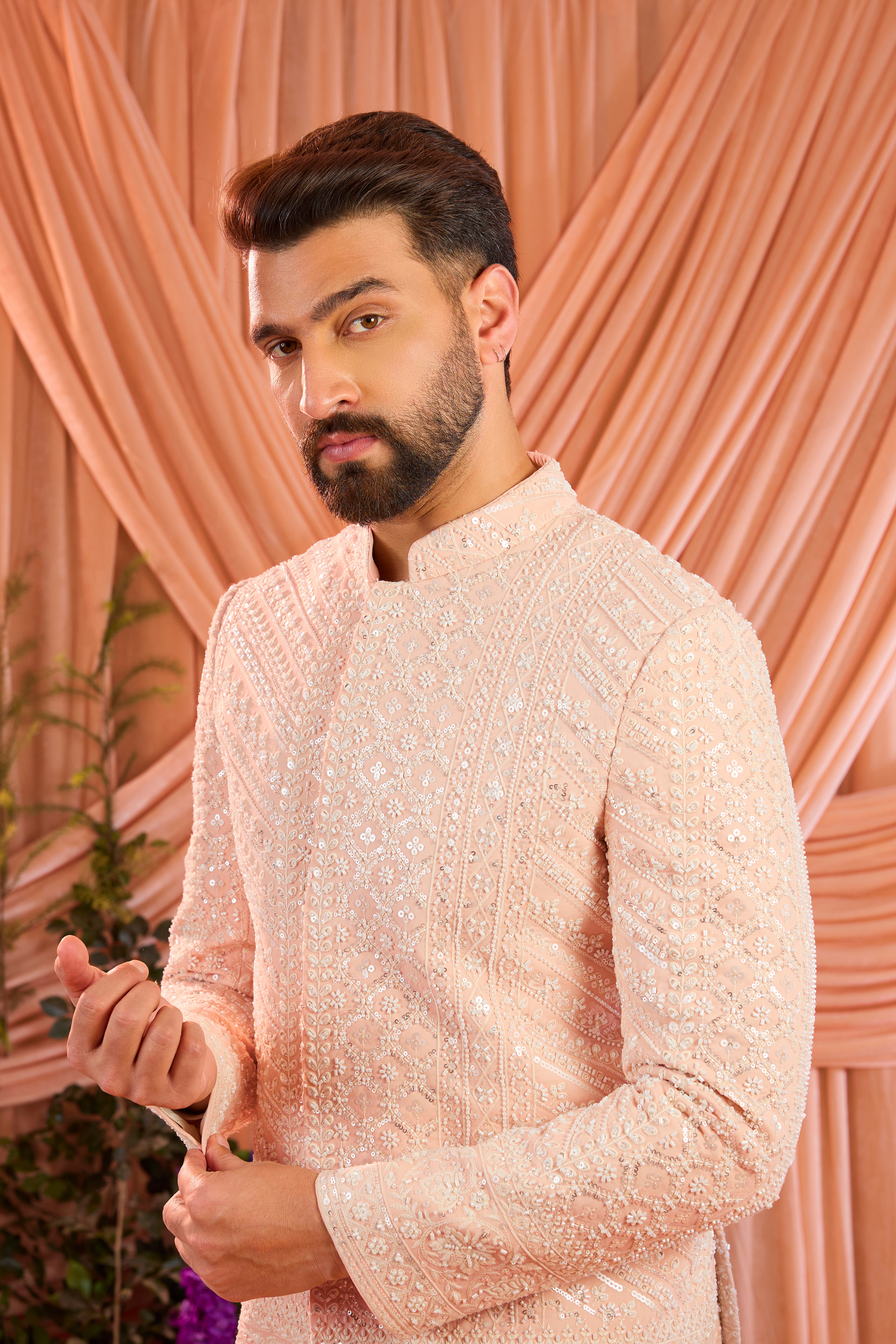 Pink  hand-embroidered formal jacket , exquisitely adorned with intricate ivory cut-dana detailing. The refined shimmer and precision craftsmanship evoke understated opulence and modern royalty.