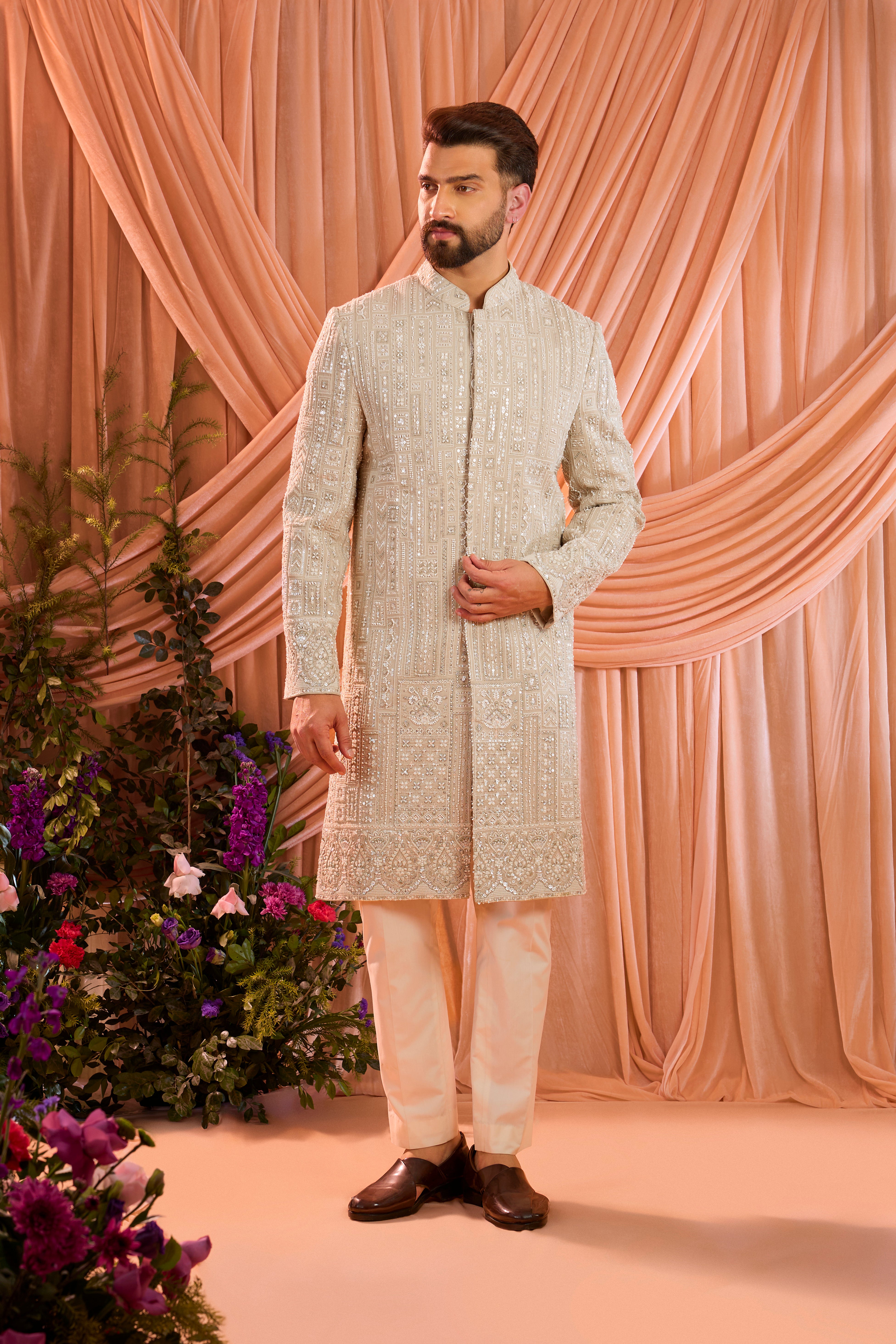 A mouse brown hand-embroidered formal sherwani, exquisitely adorned with intricate ivory cut-dana detailing.