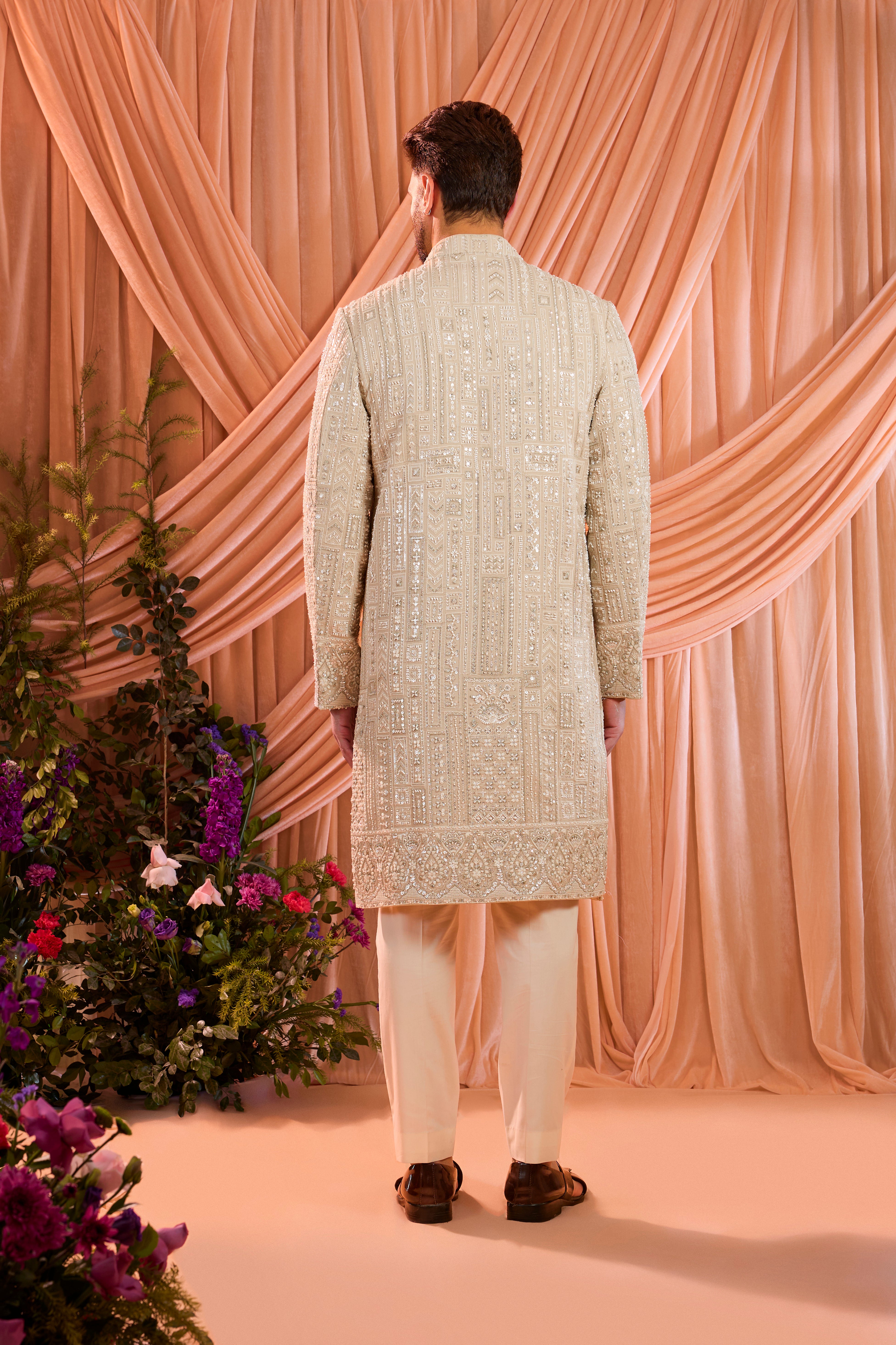 A mouse brown hand-embroidered formal sherwani, exquisitely adorned with intricate ivory cut-dana detailing.