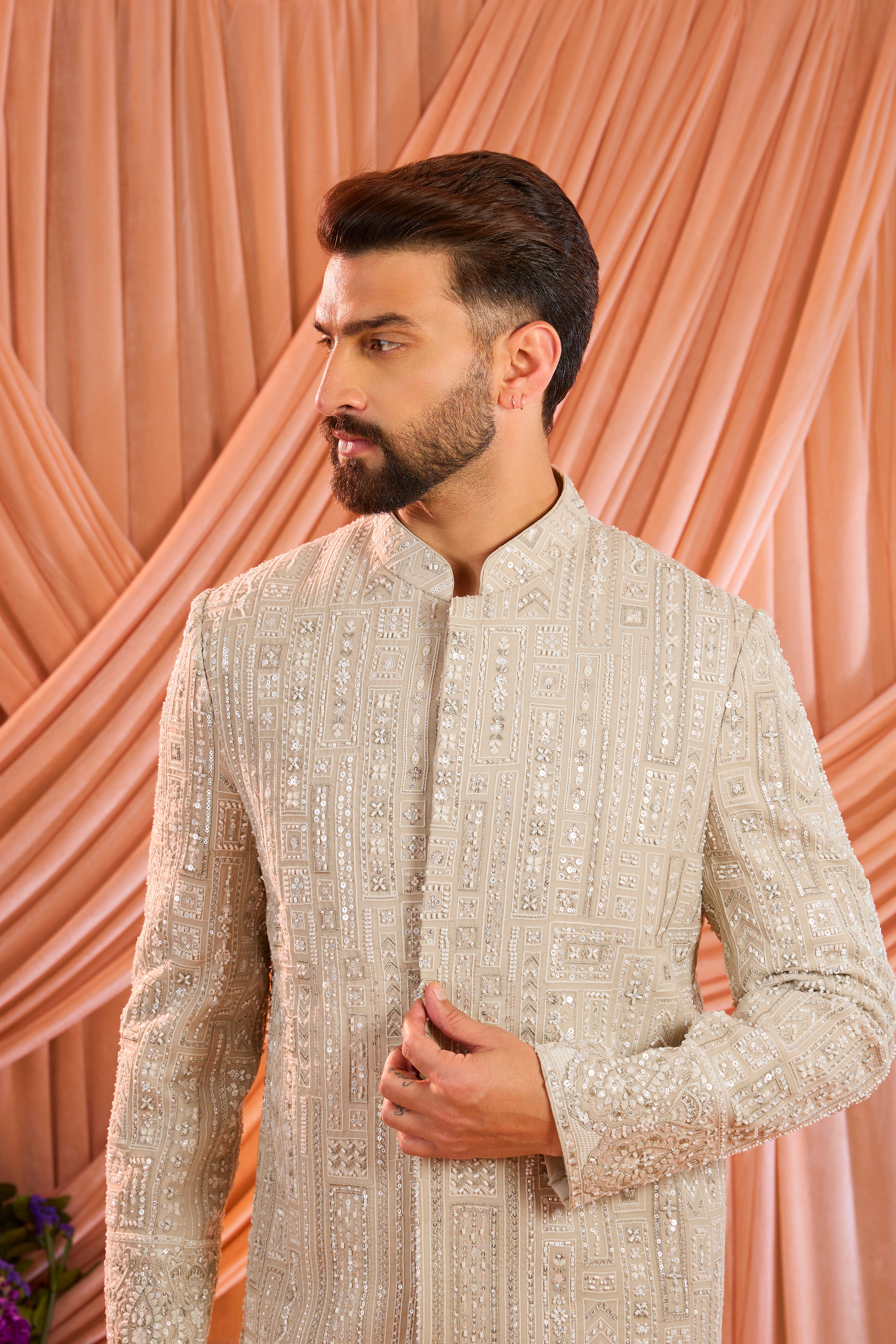 A mouse brown hand-embroidered formal sherwani, exquisitely adorned with intricate ivory cut-dana detailing.