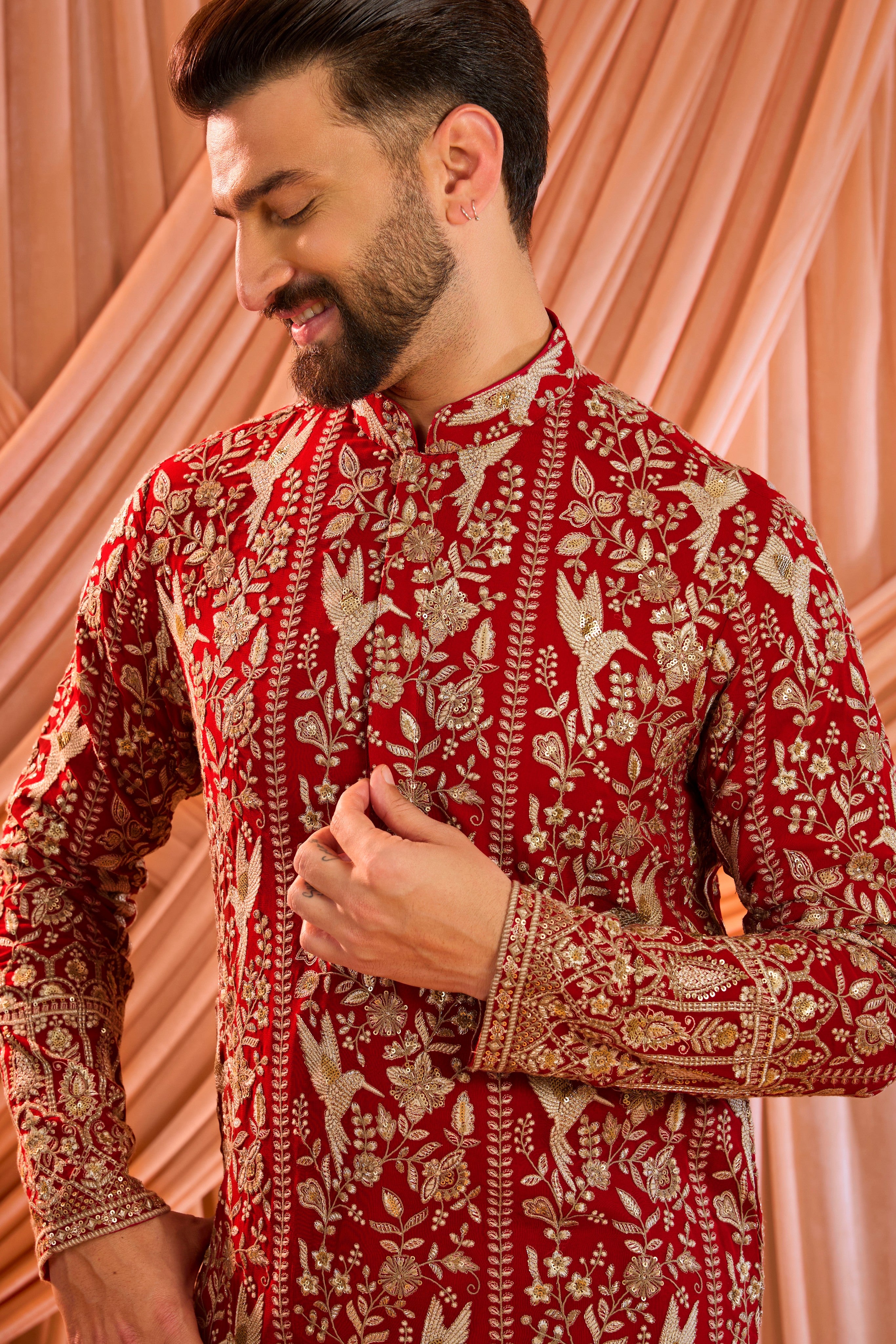 A hot pink chikankari kurta adorned with intricate flora and fauna motifs, reflecting refined artisanal craftsmanship.