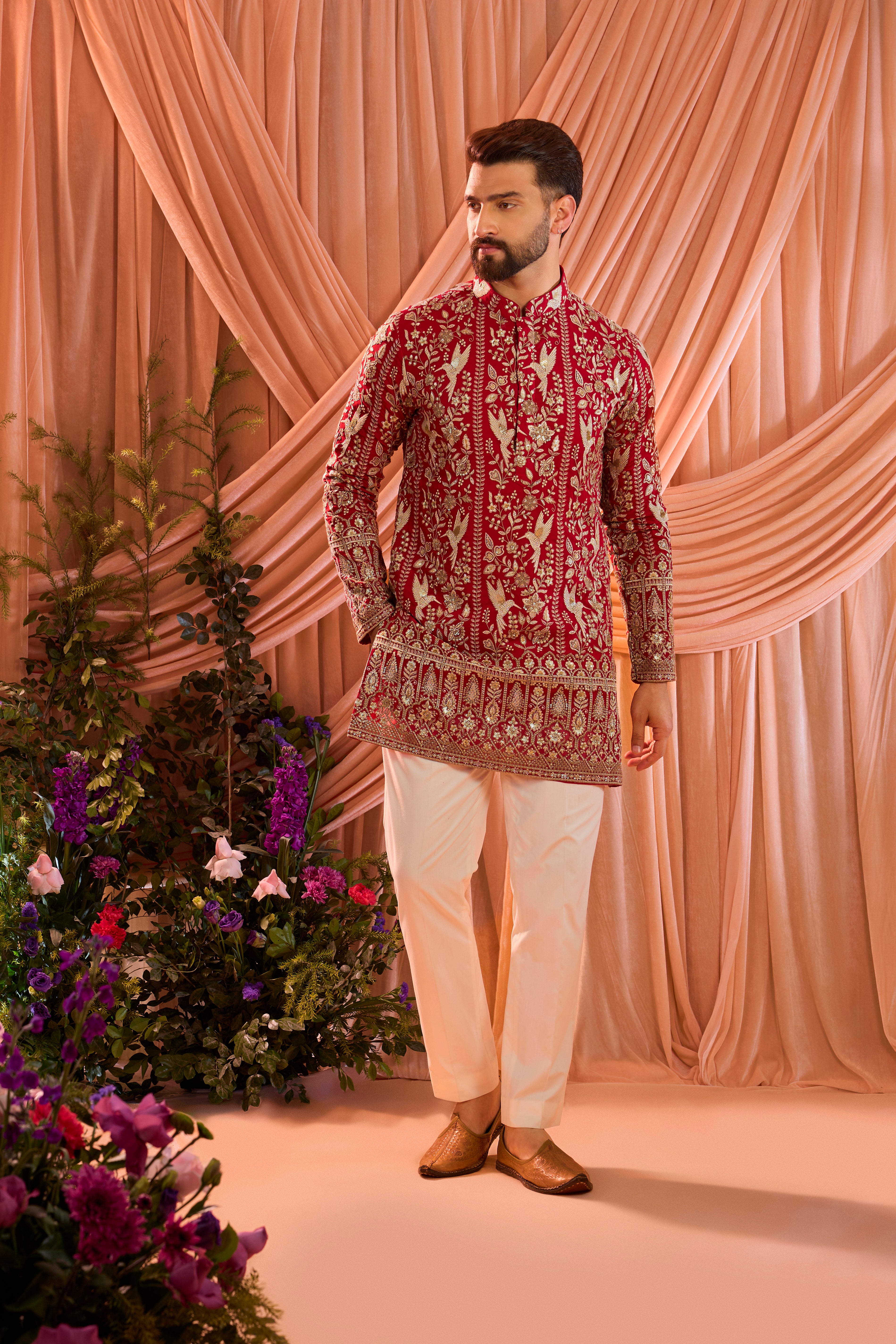 A hot pink short chikankari kurta adorned with intricate flora and fauna motifs, reflecting refined artisanal craftsmanship.