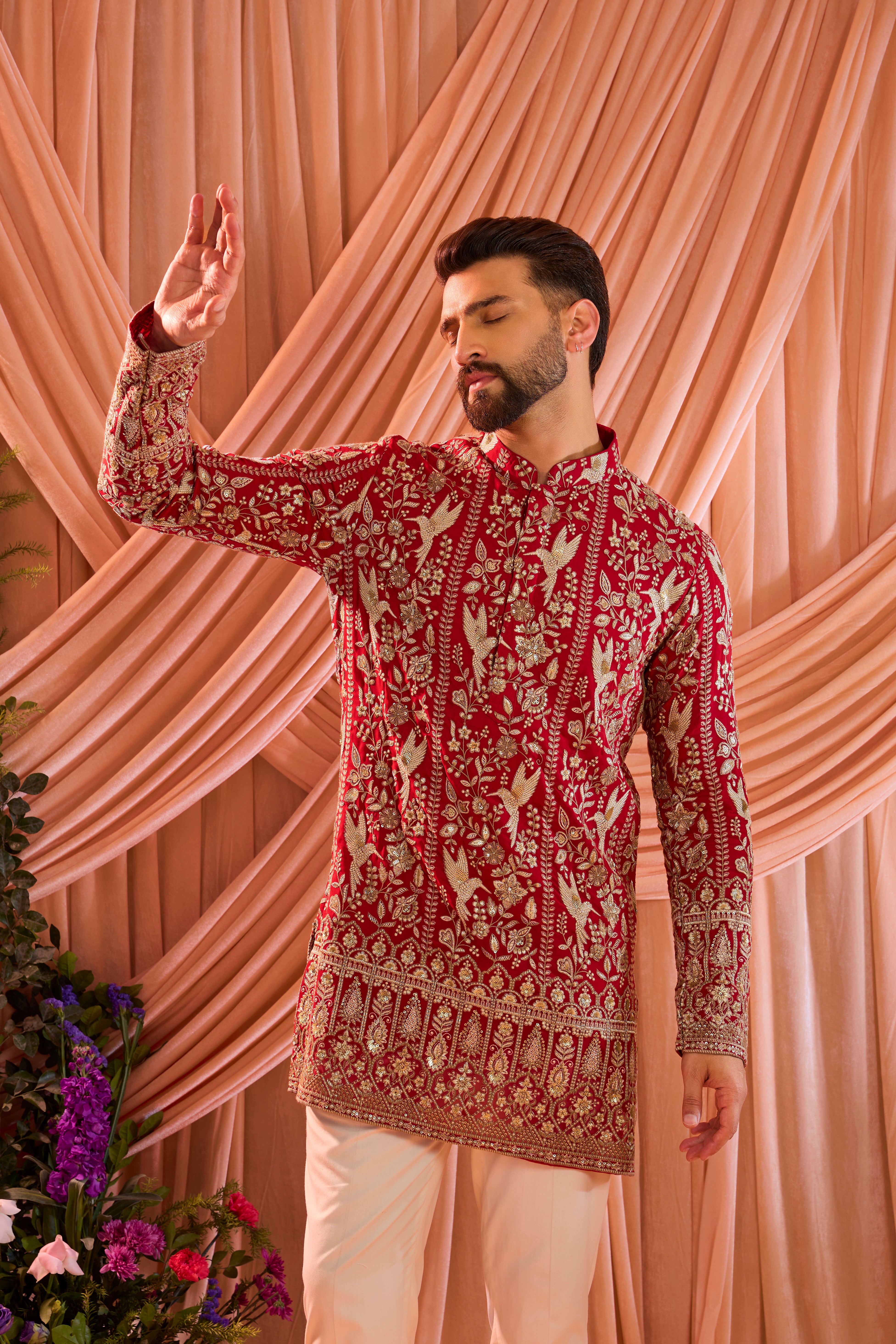 A hot pink short chikankari kurta adorned with intricate flora and fauna motifs, reflecting refined artisanal craftsmanship.