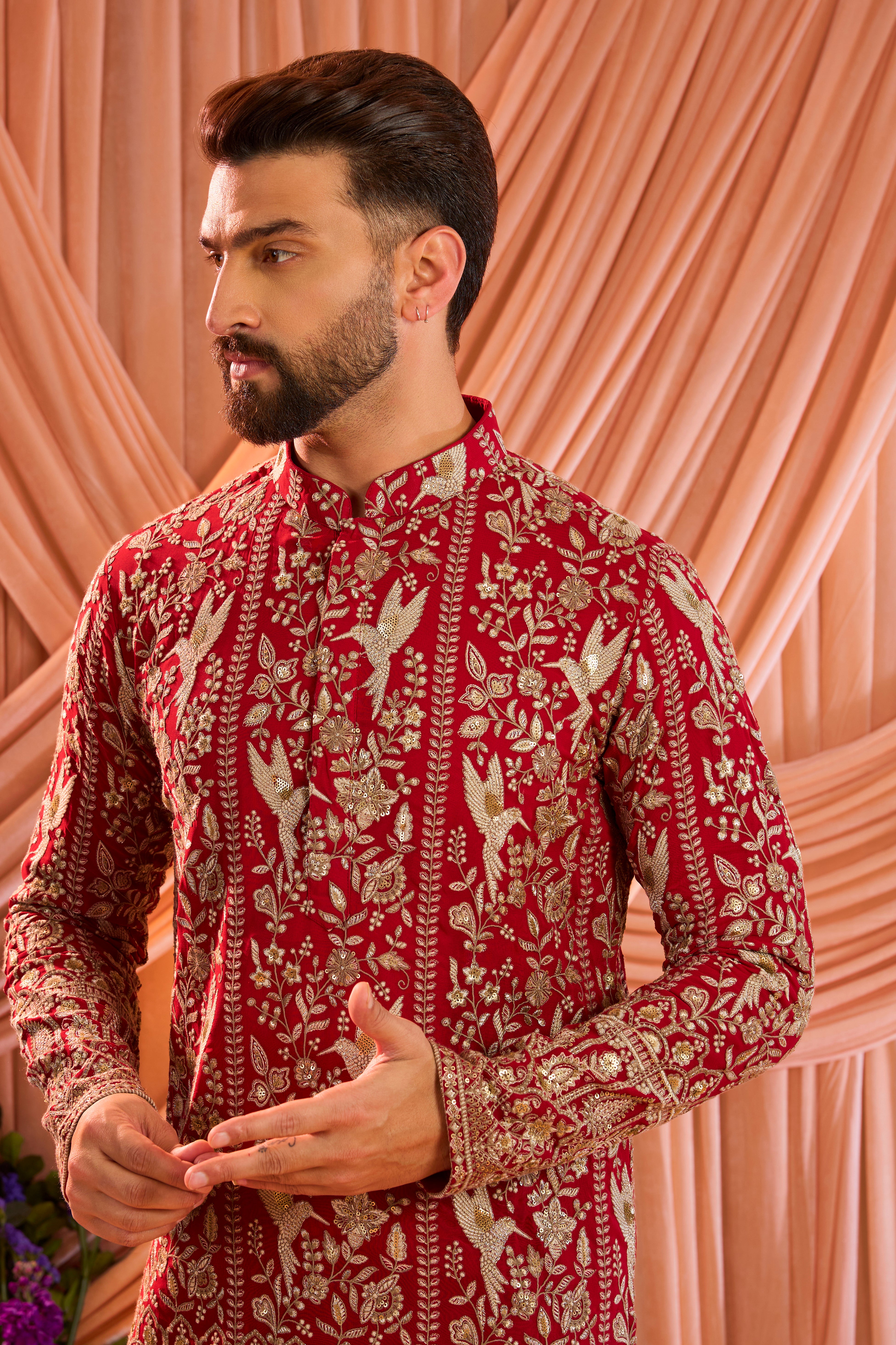 A hot pink short chikankari kurta adorned with intricate flora and fauna motifs, reflecting refined artisanal craftsmanship.