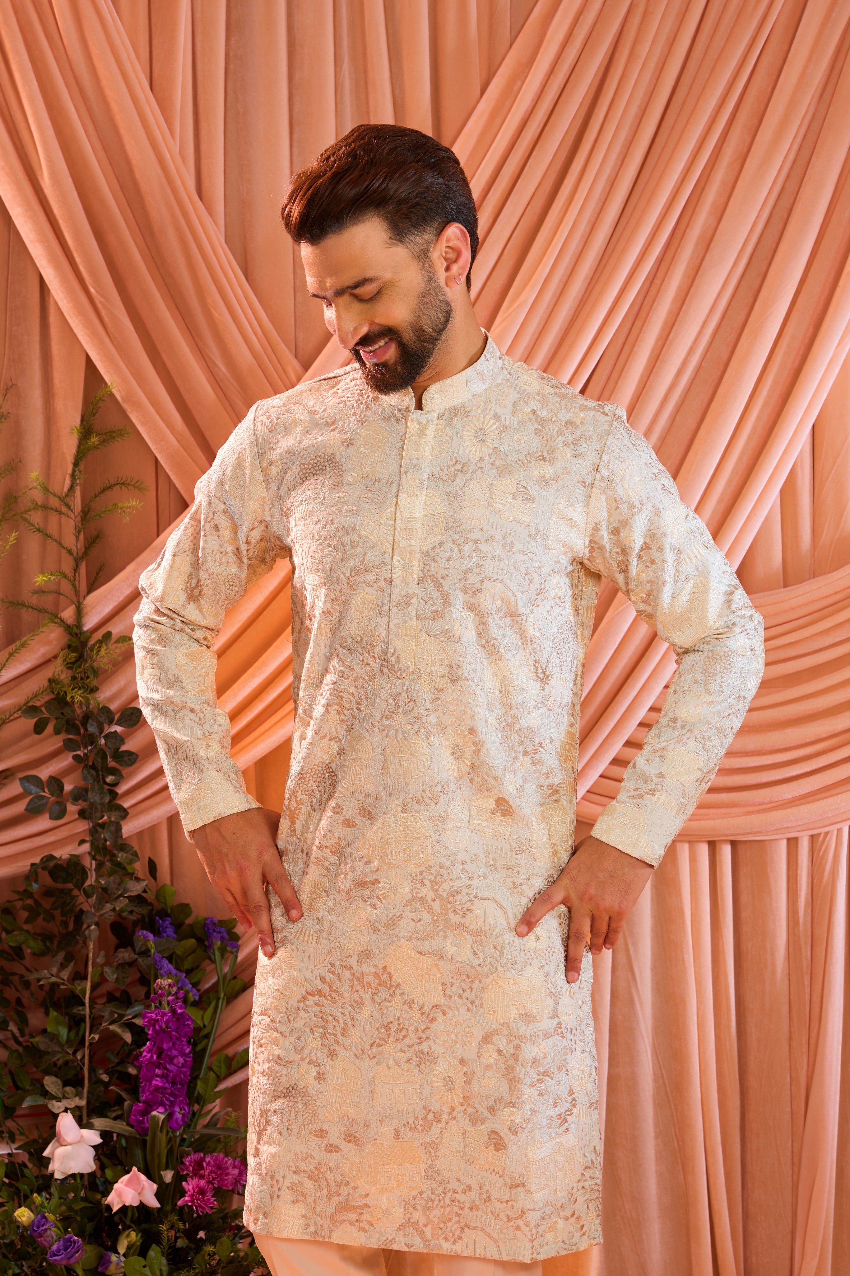 A cream tropical chikankari kurta enriched with intricate threadwork and detailed floral motifs, inspired by a vintage homes era.