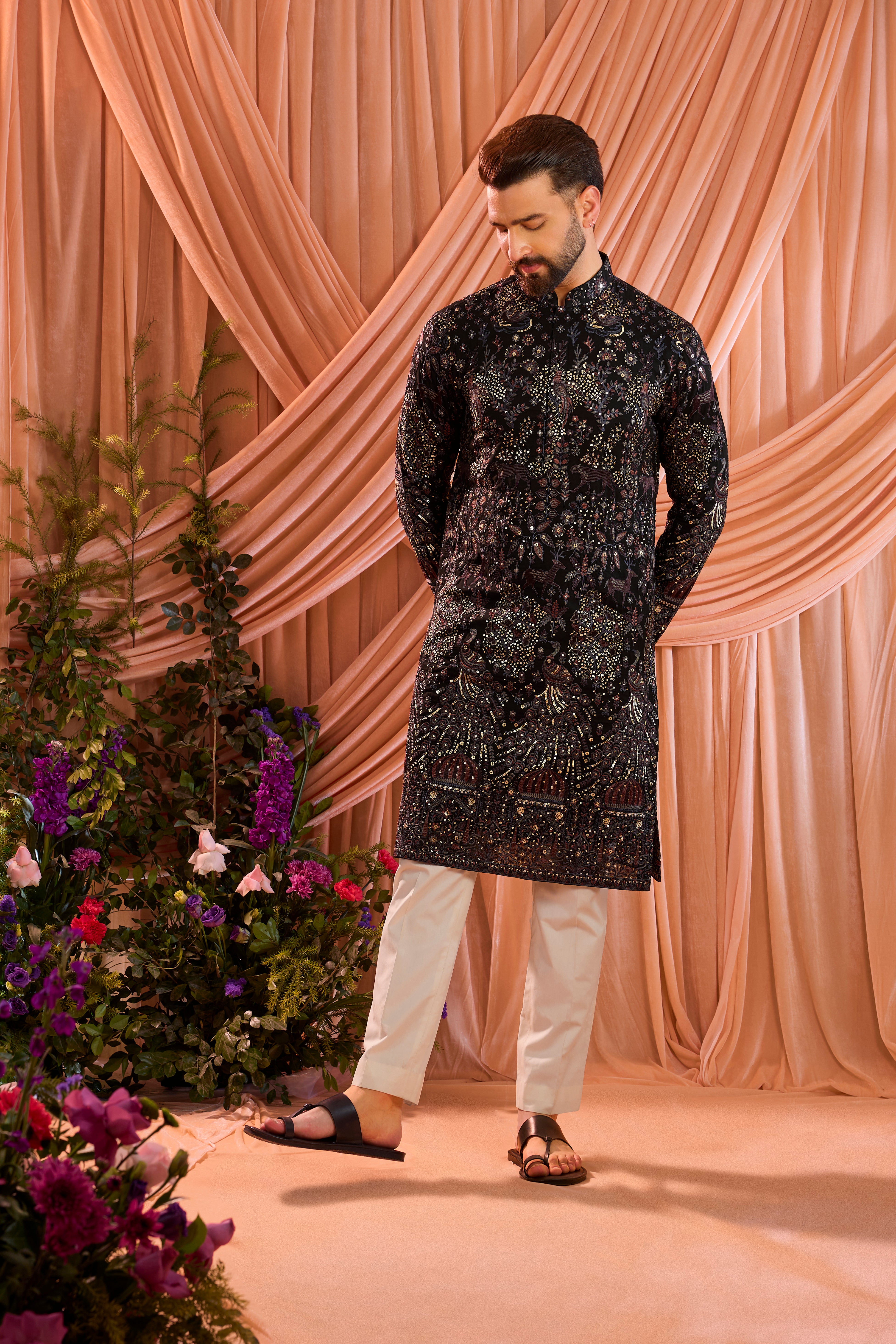 A blue/multi coloured royal heritage kurta adorned with detailed flora and fauna motifs and intricate darbar scenes.