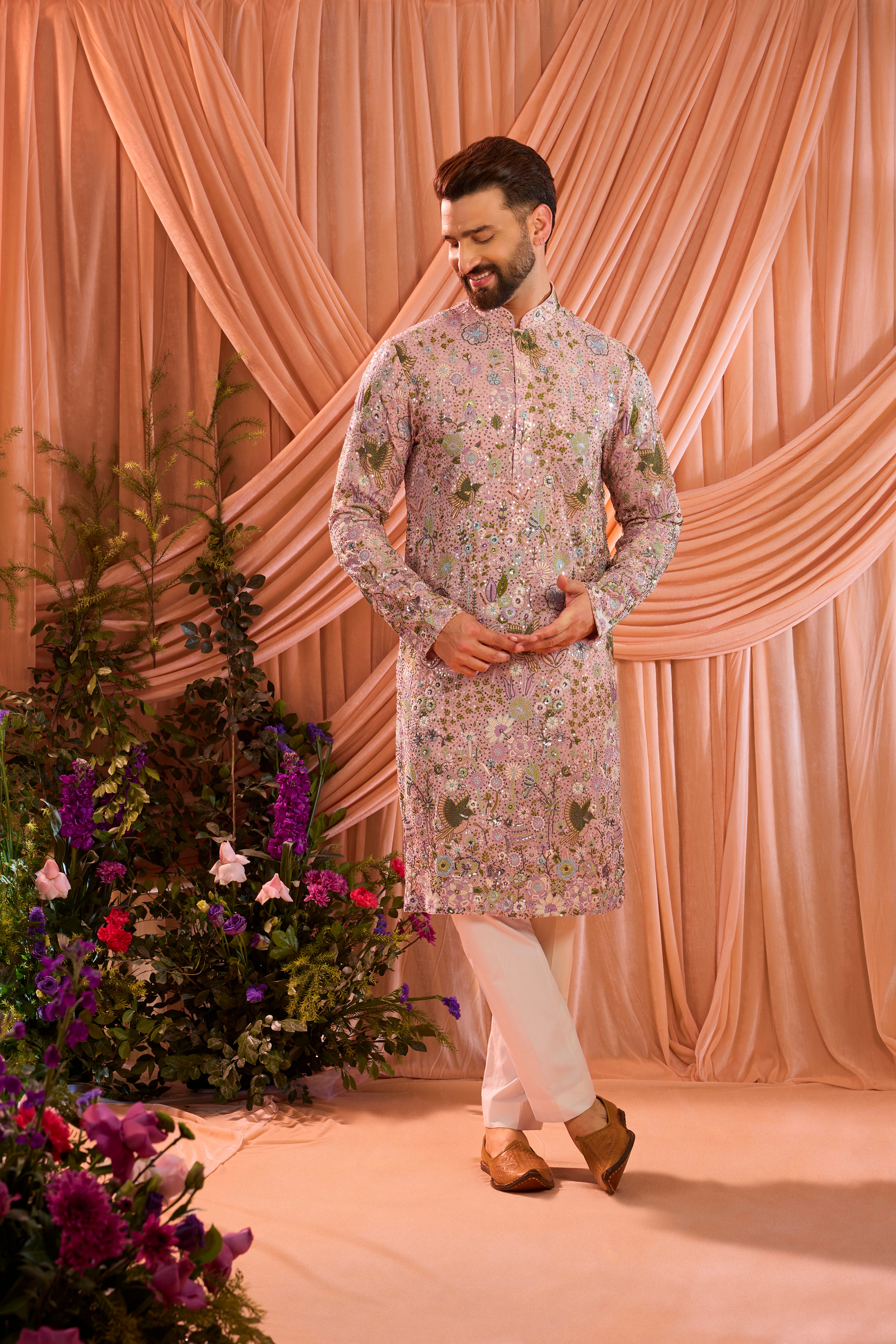 A pink sequined  kurta adorned with detailed flora and fauna motifs, brought to life through intricate multi-thread embroidery.