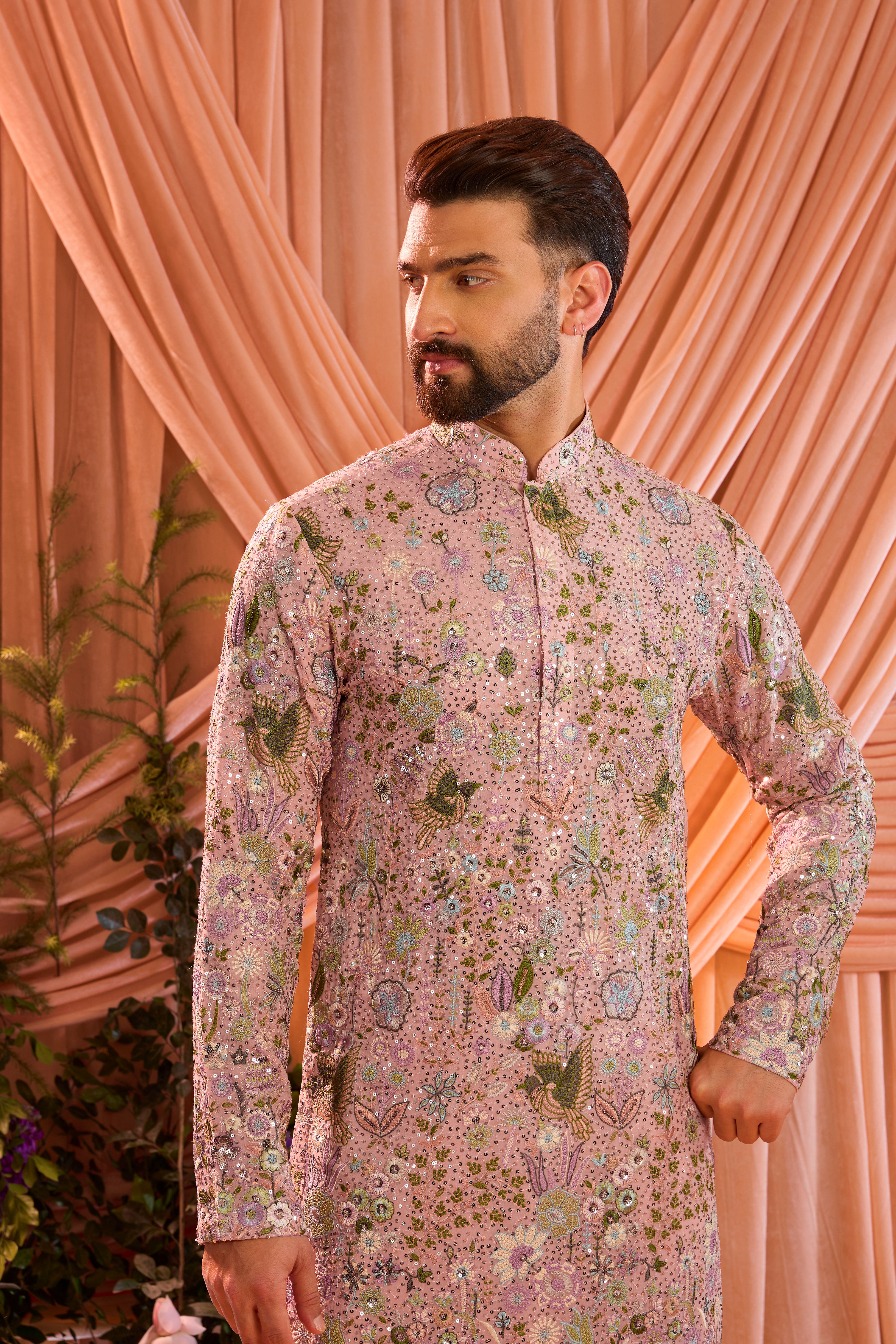 A pink sequined  kurta adorned with detailed flora and fauna motifs, brought to life through intricate multi-thread embroidery.