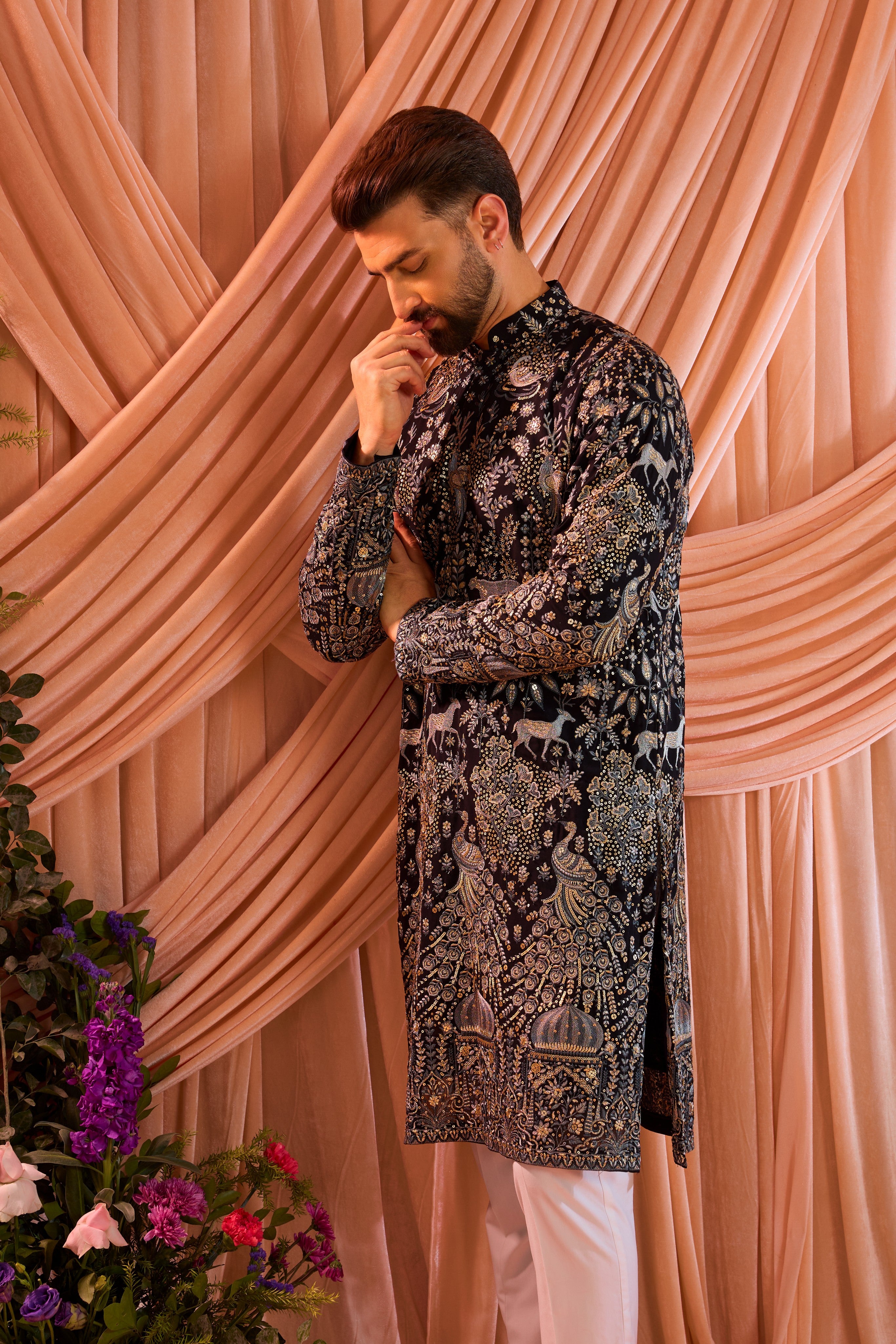 A blue royal heritage kurta adorned with detailed flora and fauna motifs and intricate darbar scenes.