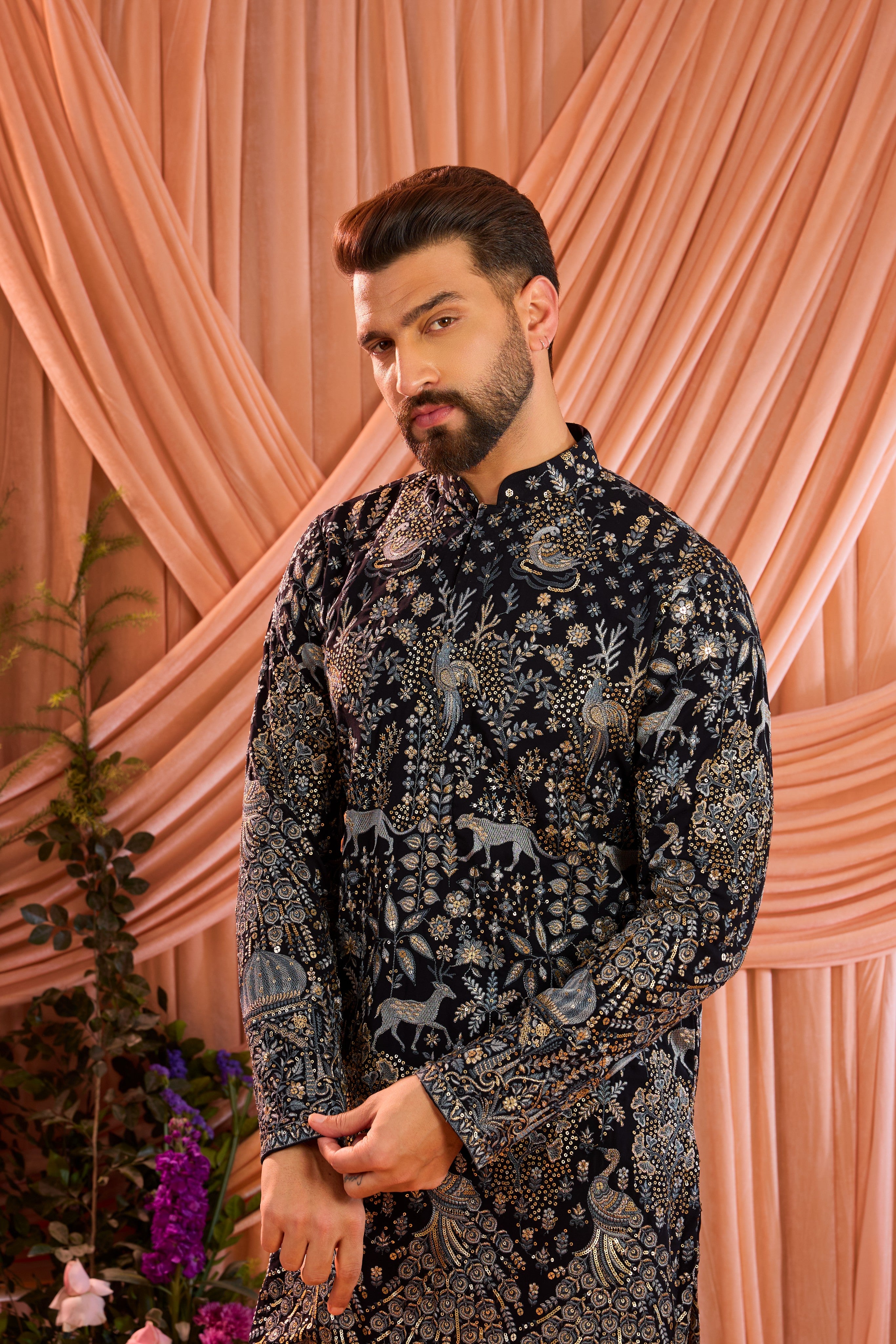 A blue royal heritage kurta adorned with detailed flora and fauna motifs and intricate darbar scenes.