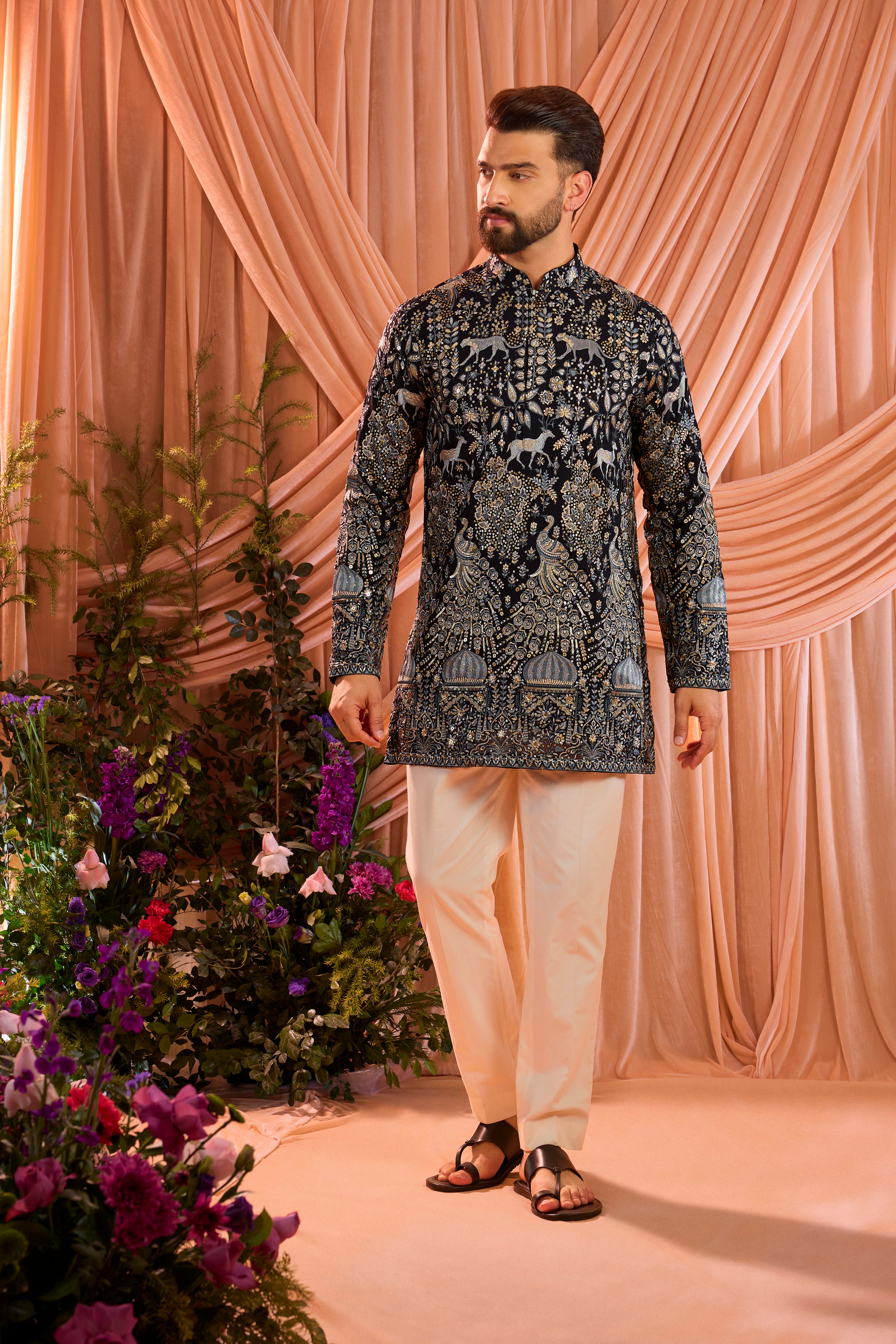 A blue royal heritage short kurta adorned with detailed flora and fauna motifs and intricate darbar scenes.