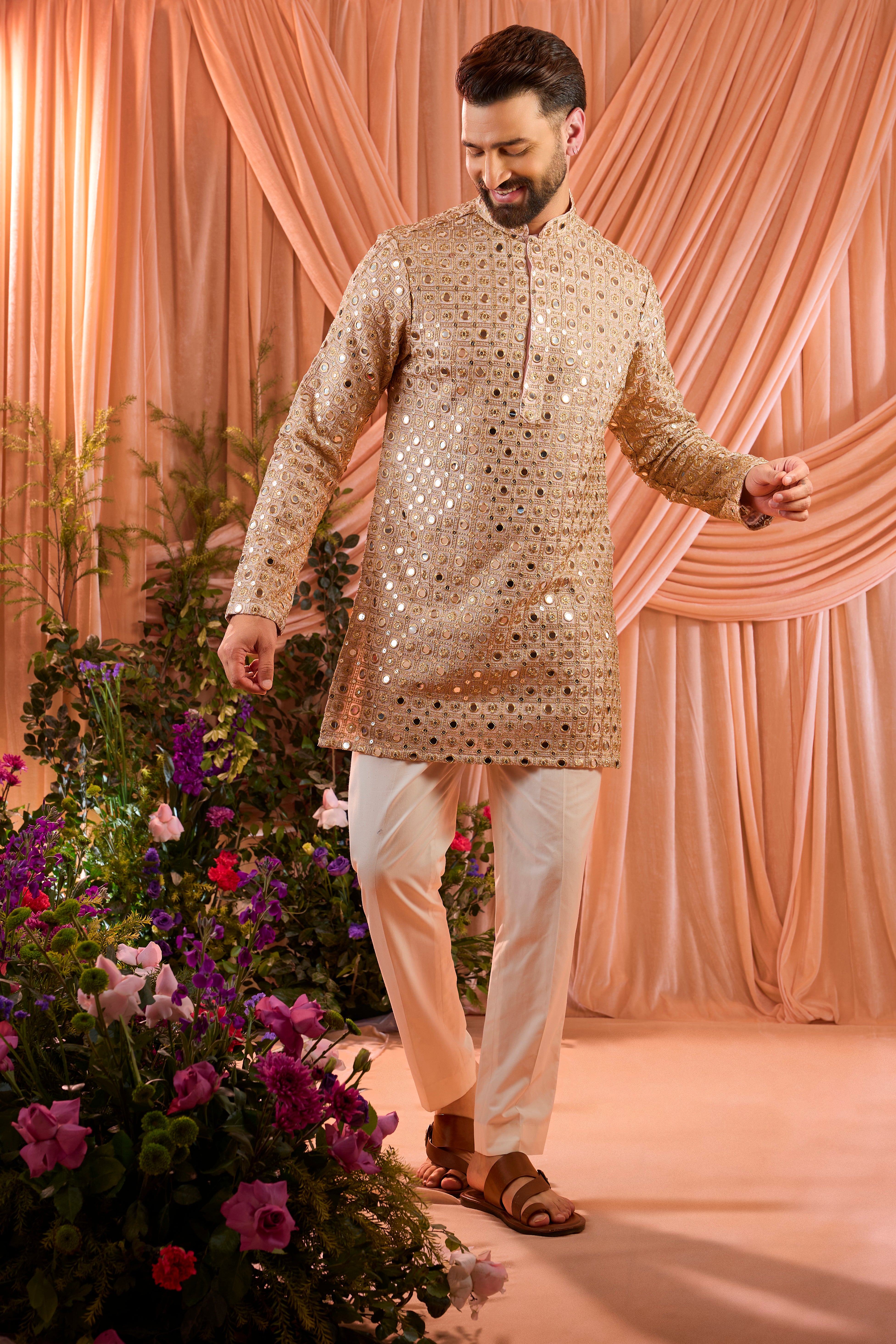 A pink short kurta featuring mirror-inspired sequin work that captures the brilliance of traditional mirror craftsmanship.
