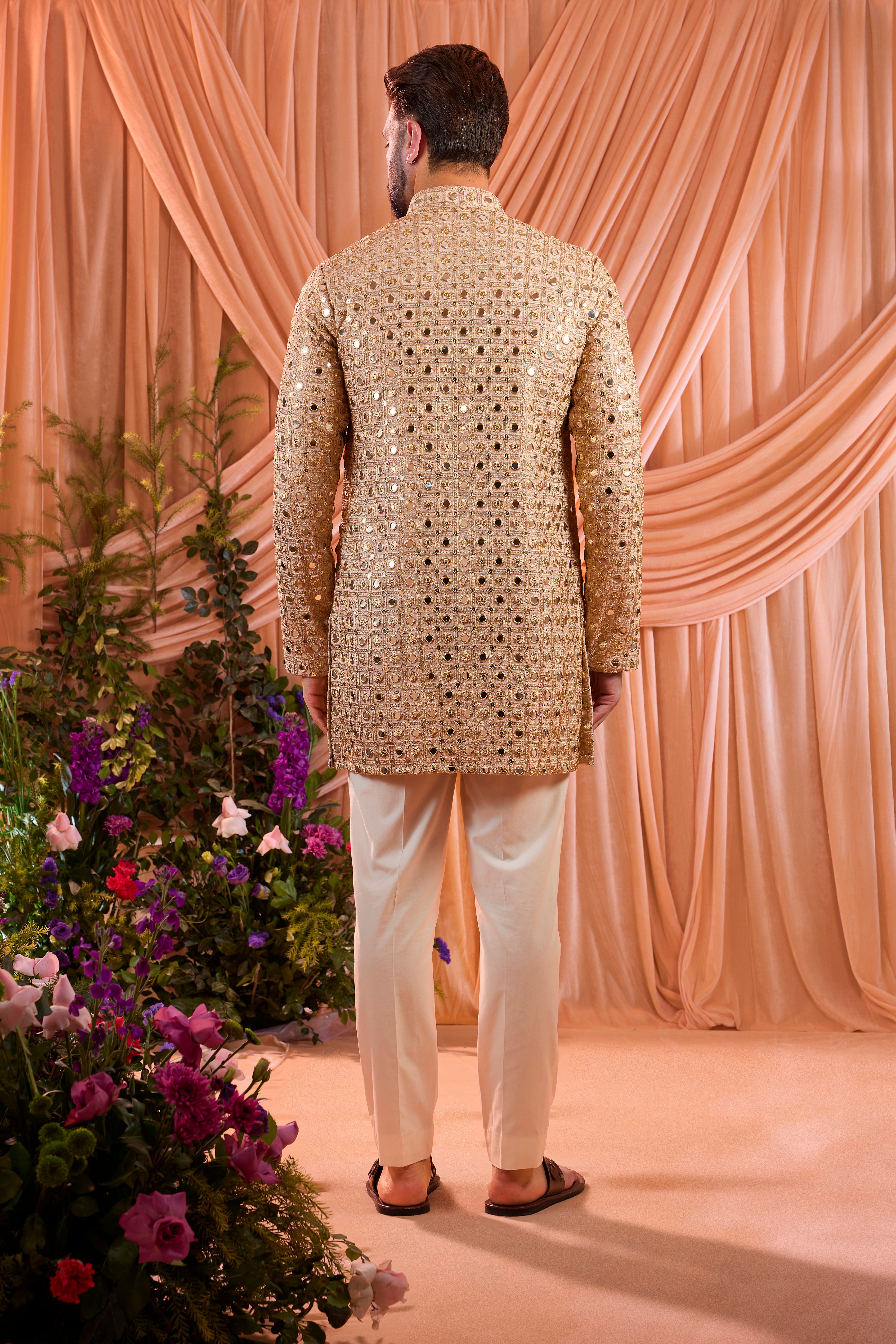 A pink short kurta featuring mirror-inspired sequin work that captures the brilliance of traditional mirror craftsmanship.