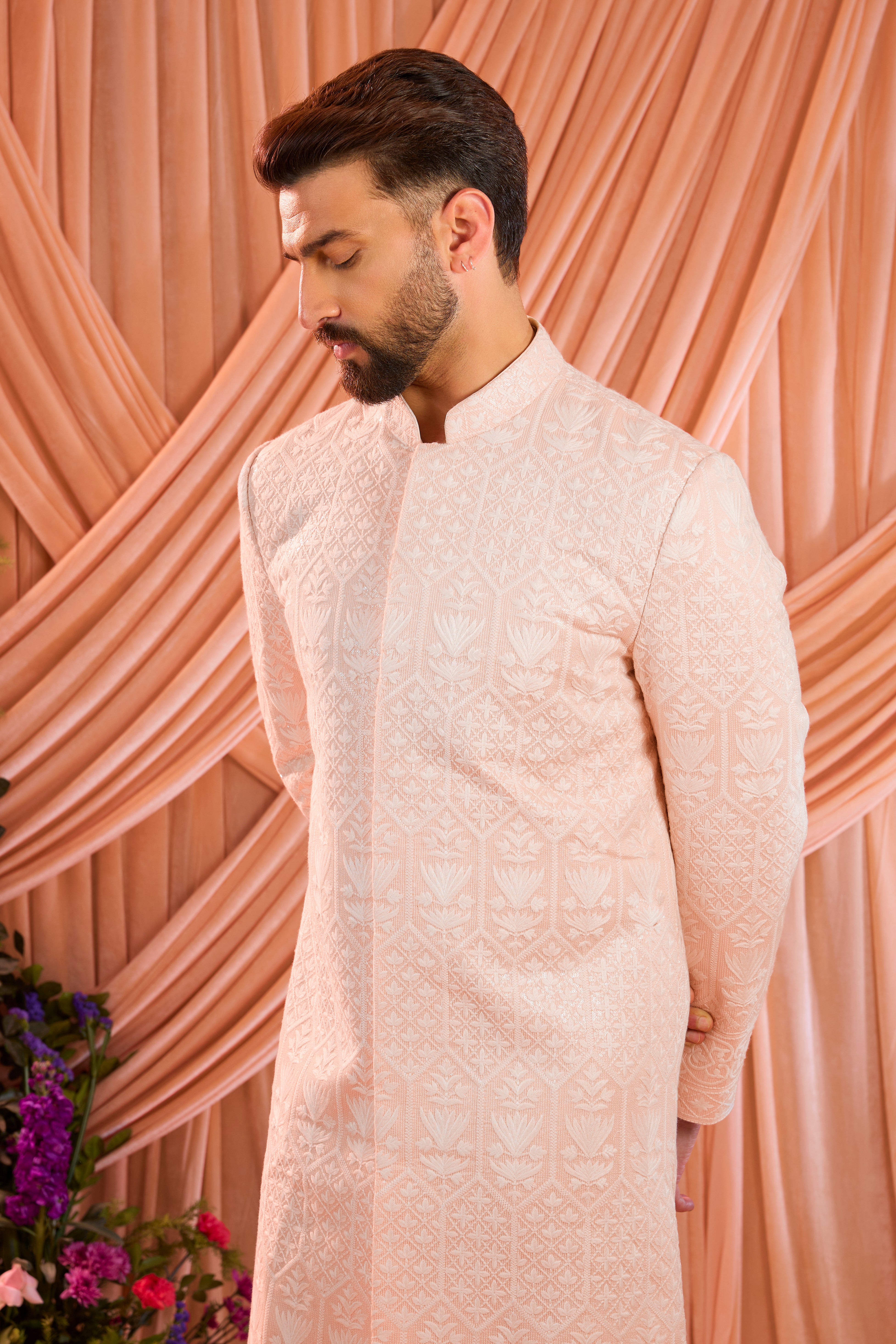 Pink chikankari sherwani distinguished by heavy ivory threadwork and meticulously detailed sequin embellishment