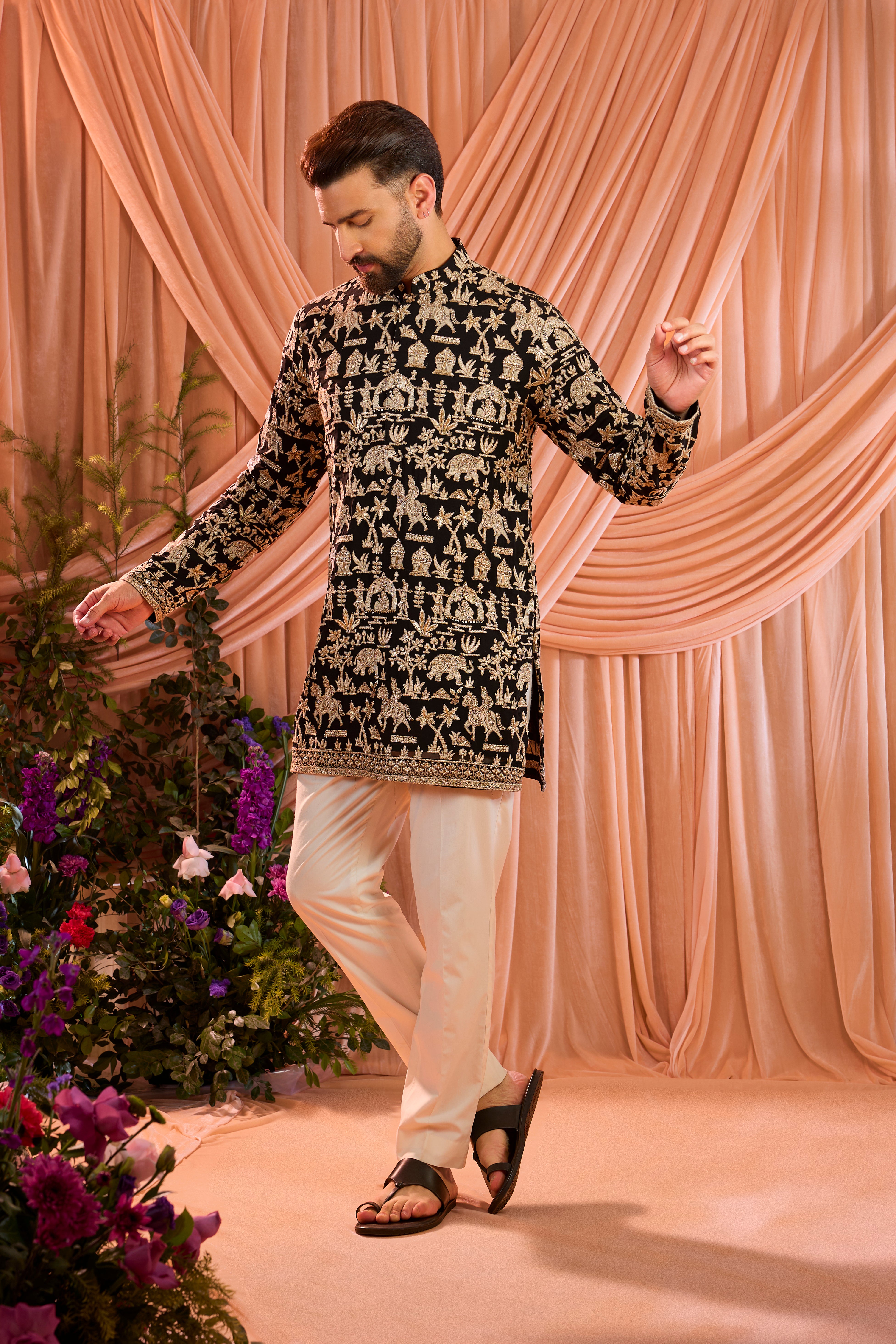 Black royal-heritage kurta adorned with intricately detailed Mughal-era motifs, reflecting the grandeur of imperial artistry.