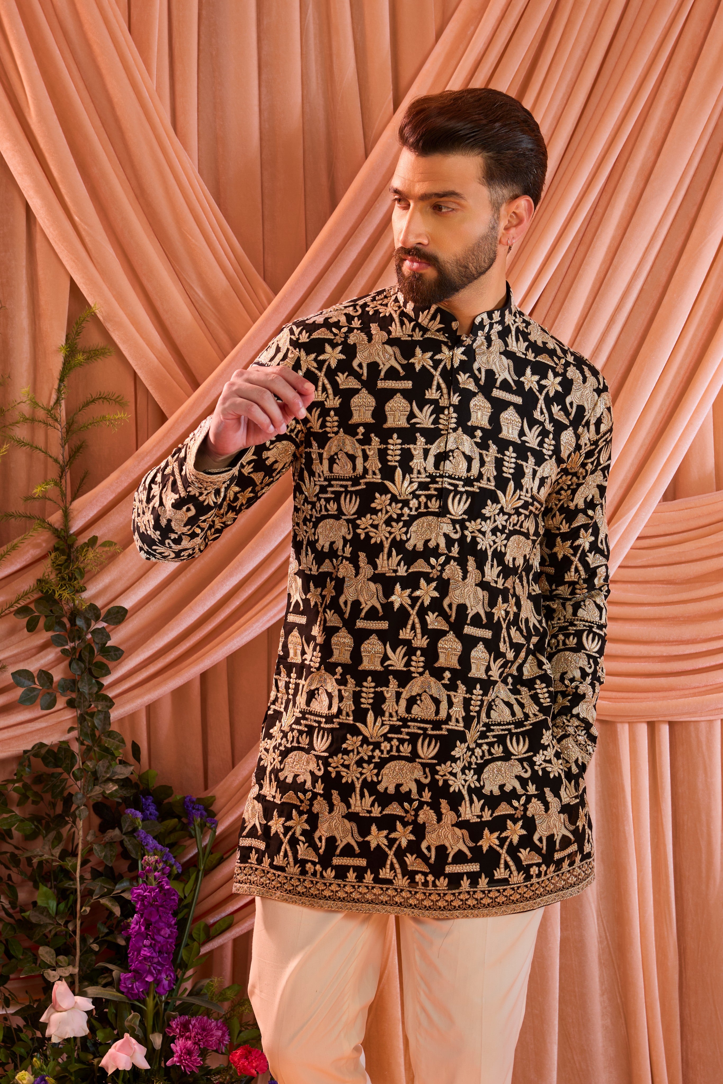 Black royal-heritage kurta adorned with intricately detailed Mughal-era motifs, reflecting the grandeur of imperial artistry.