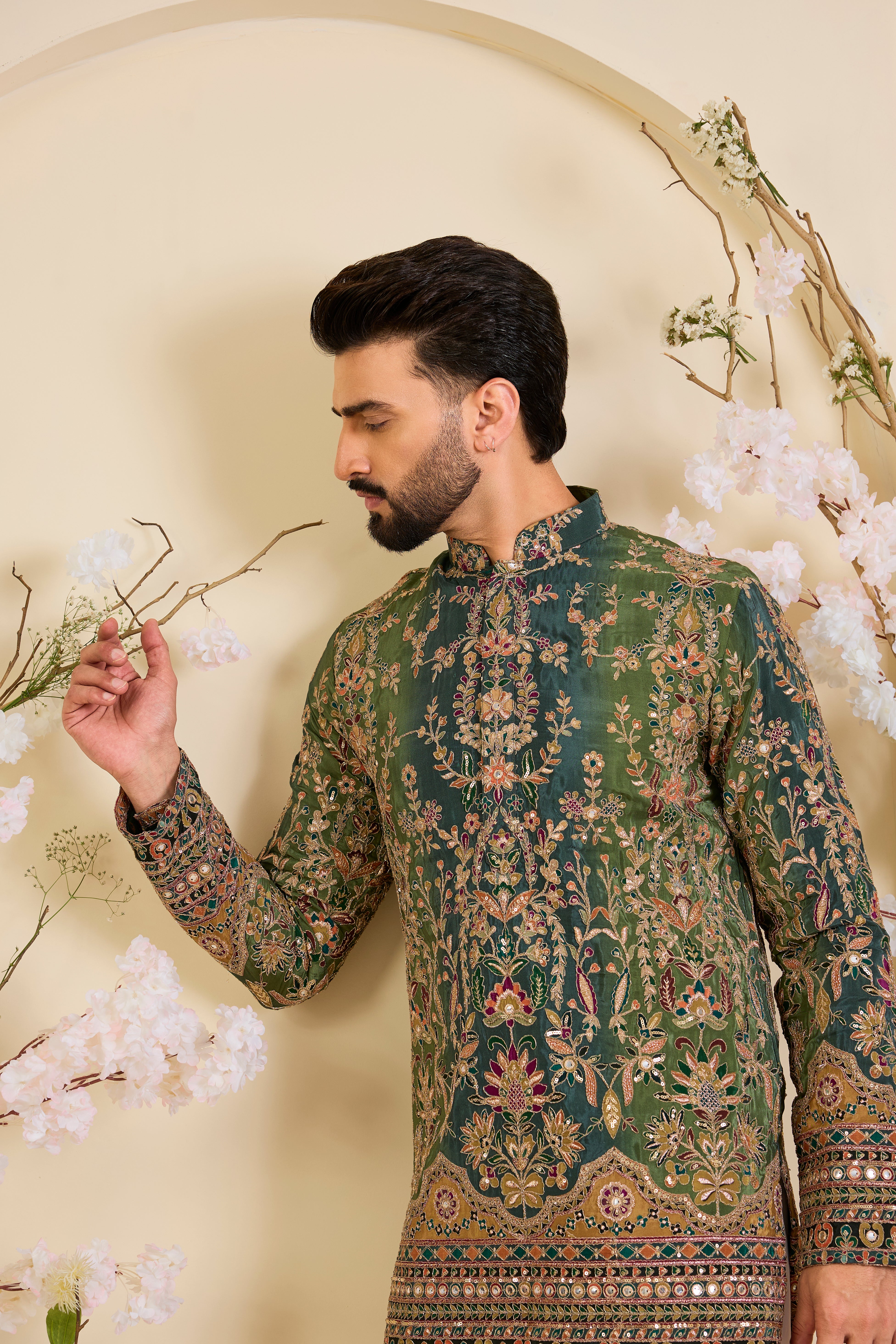 Green crepe short kurta with intricate zari work, vibrant multicolour prints, and refined sequin detailing.