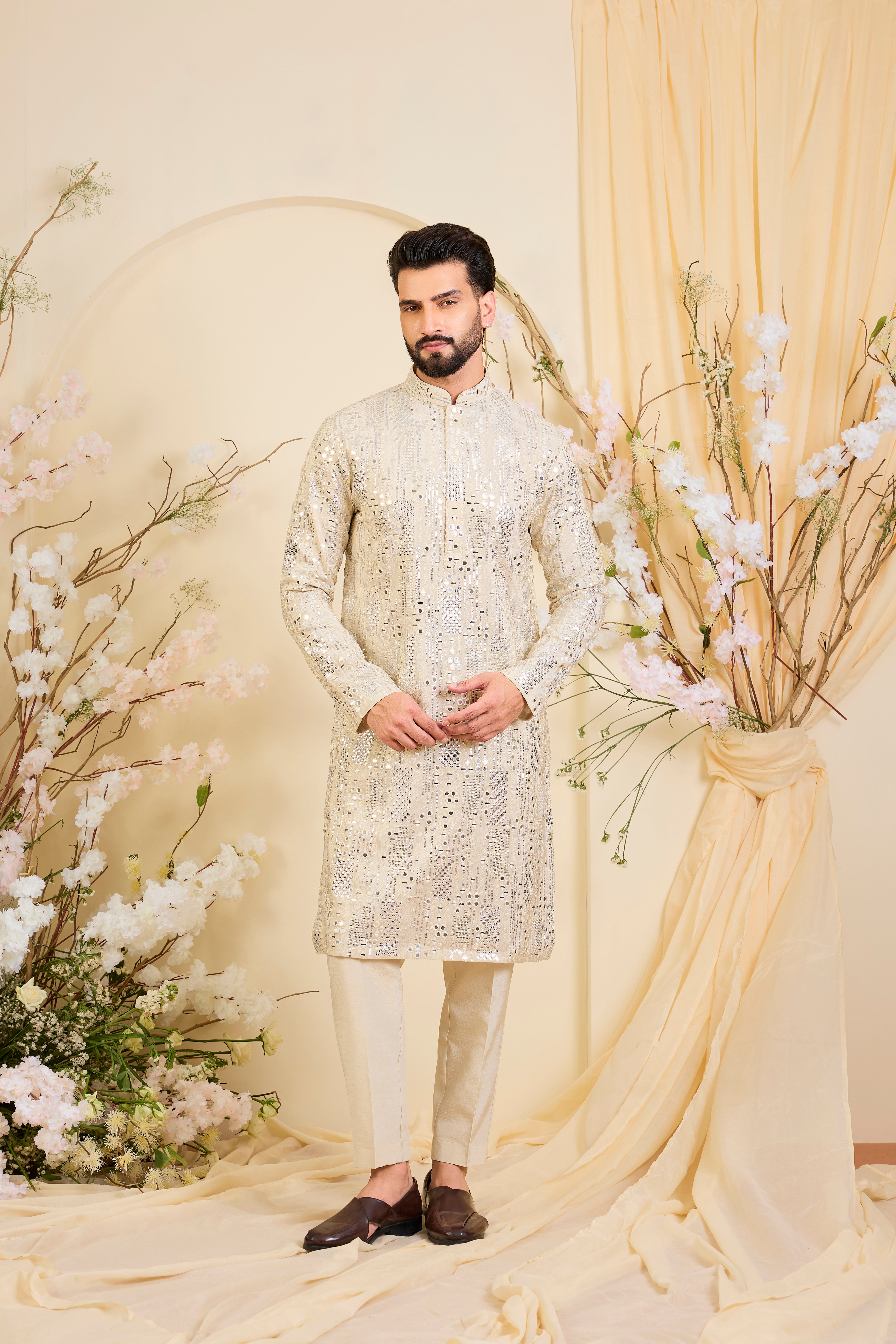 Golden tissue long kurta with intricate sequin mirrorwork and tone-on-tone threadwork. A luminous take on understated opulence.