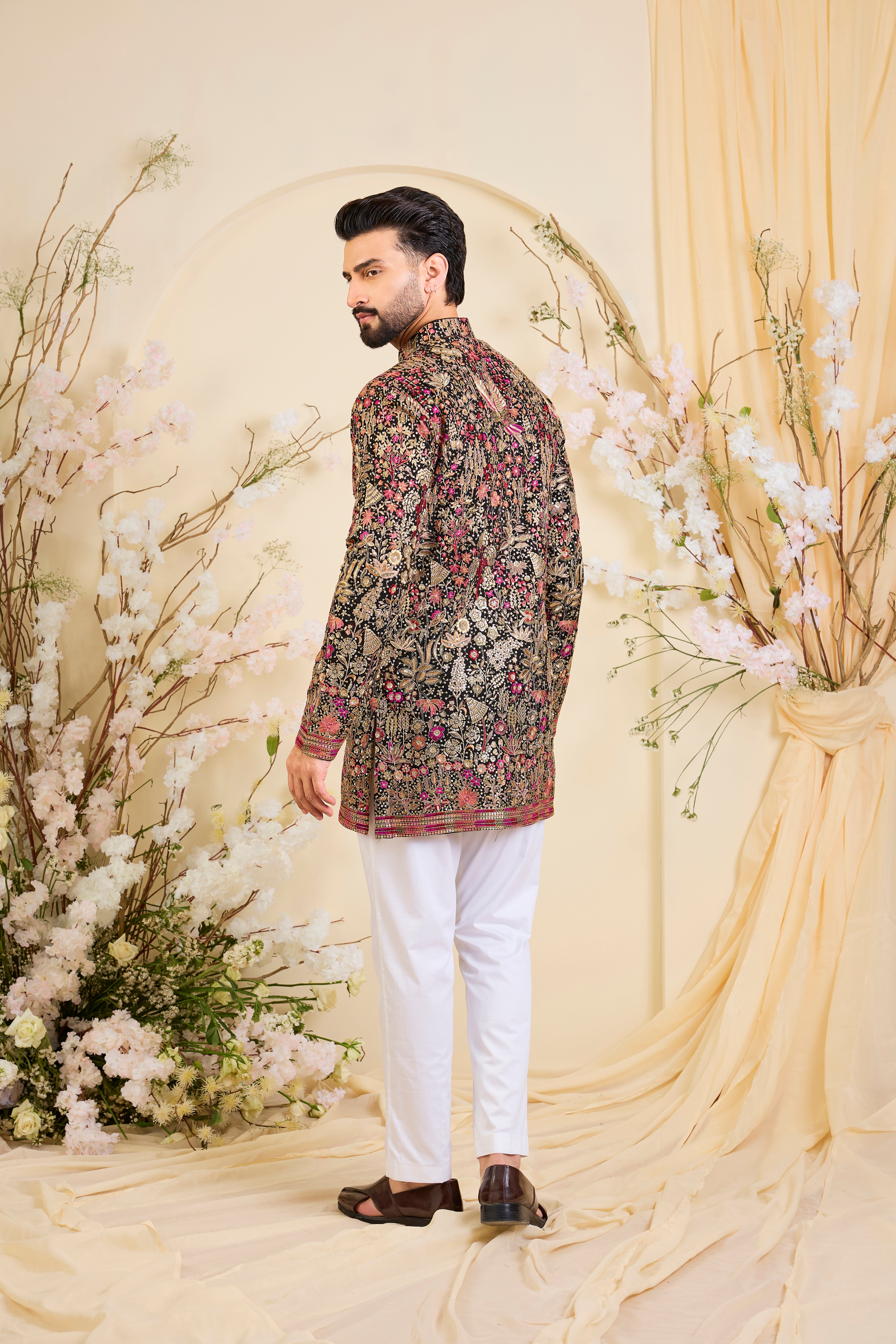 Black short kurta with intricate multicolour flora and fauna embroidery, elevated with zari accents and dense sequin detailing. A statement in formal luxury.