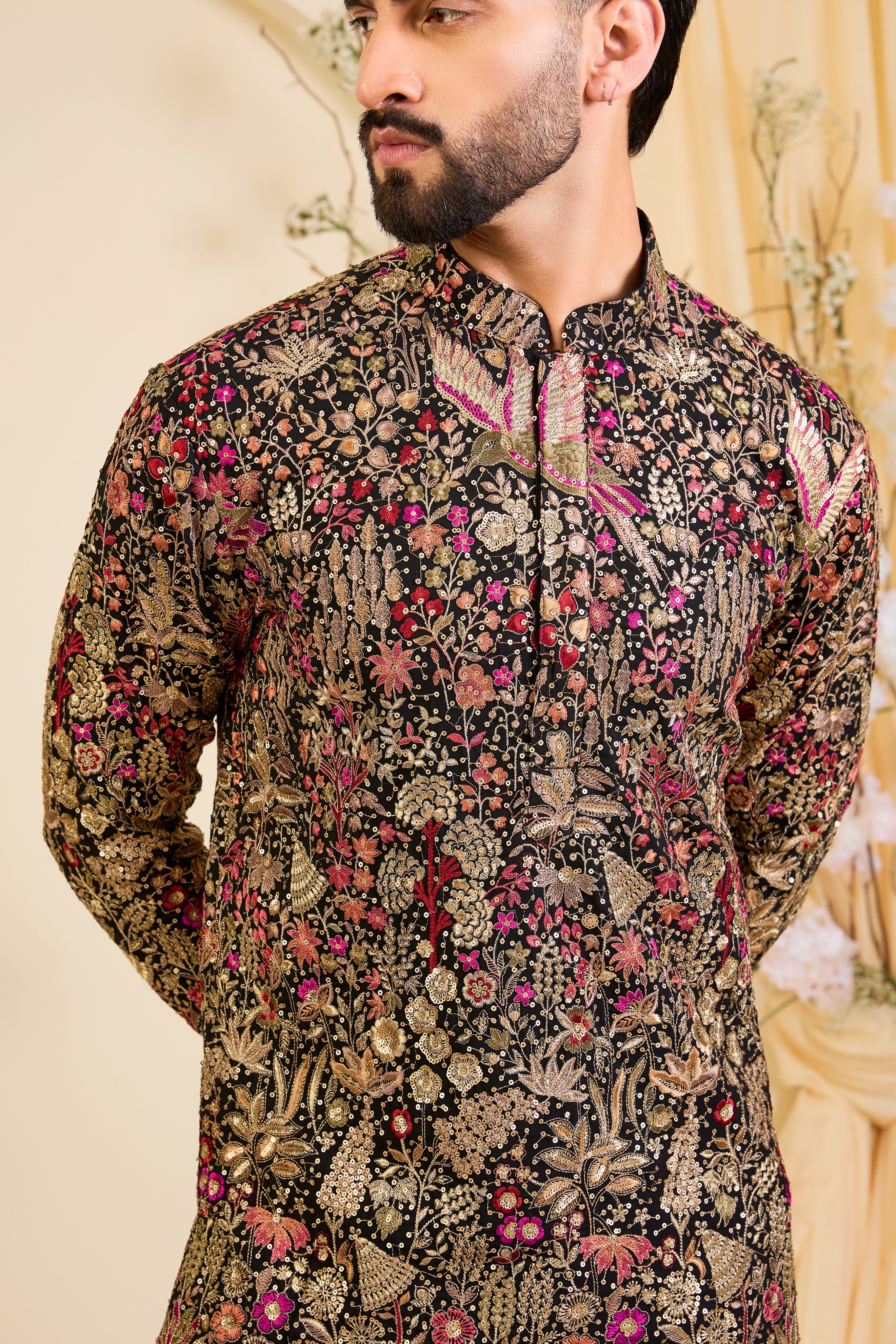 Black short kurta with intricate multicolour flora and fauna embroidery, elevated with zari accents and dense sequin detailing. A statement in formal luxury.