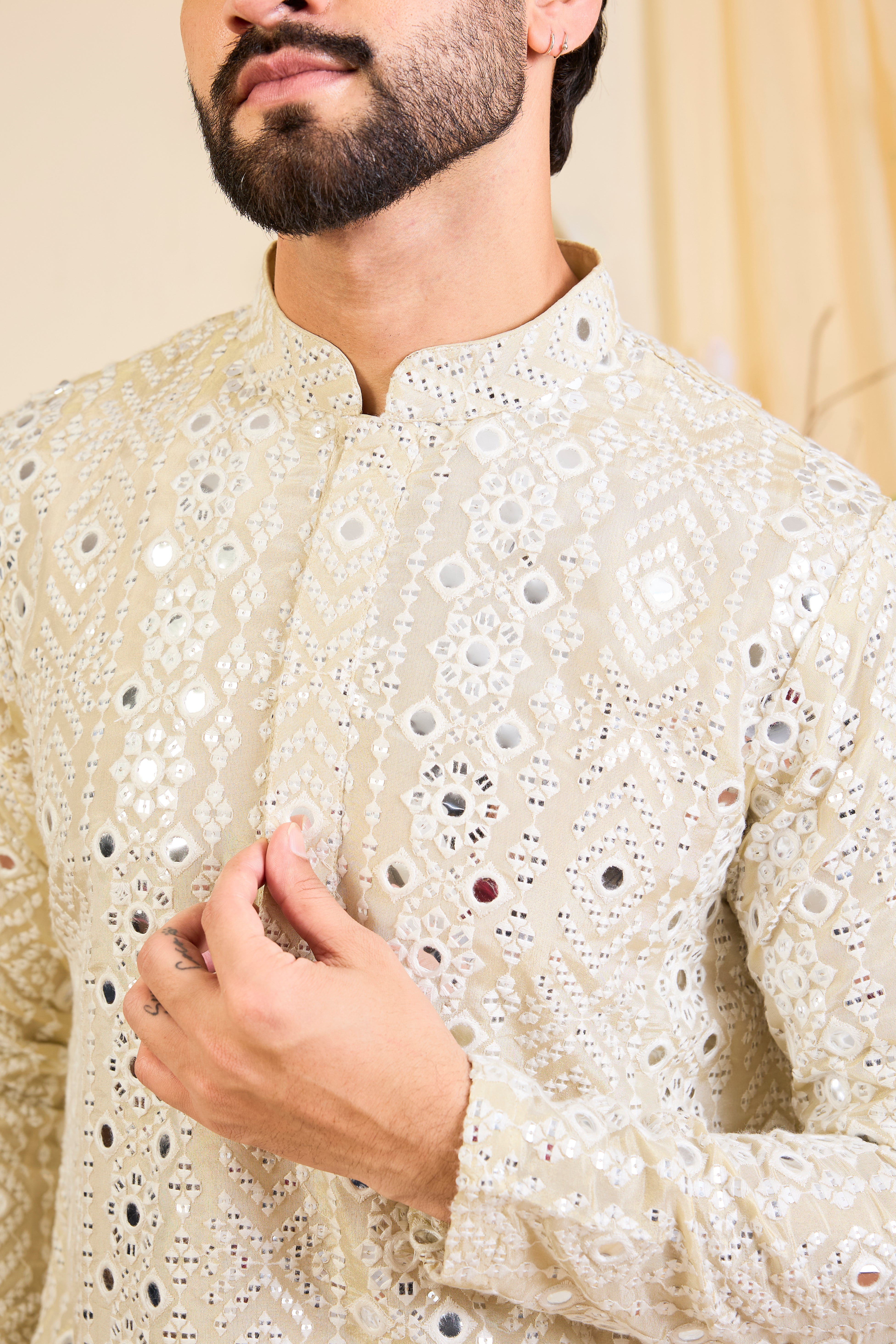 Golden tissue short kurta with intricate sequin mirrorwork and tone-on-tone threadwork. A luminous take on understated opulence.
