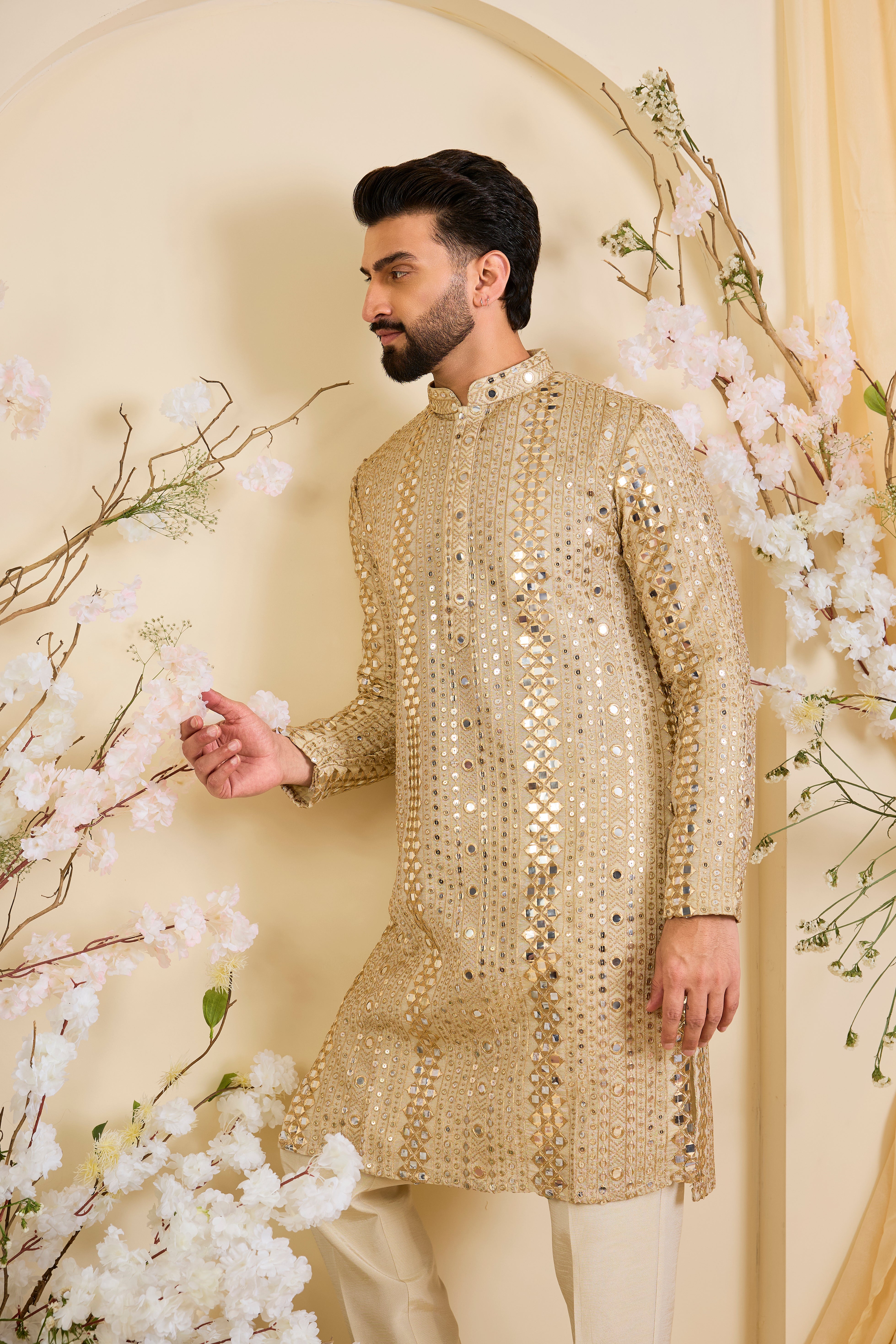 Golden tissue long kurta with intricate sequin mirrorwork and tone-on-tone threadwork. A luminous take on understated opulence.