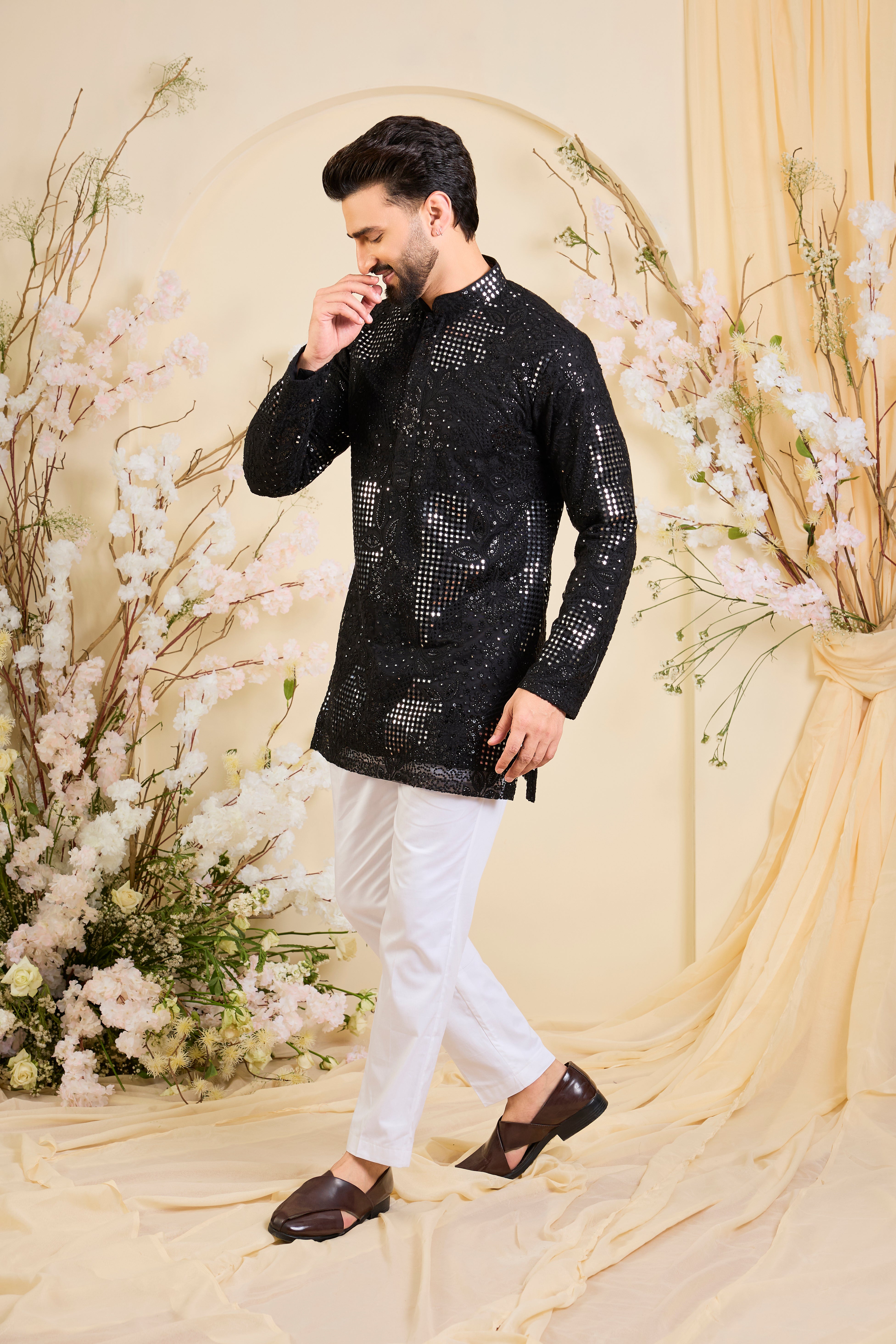 Black short kurta with sequin mirrorwork and delicate floral embroidery, offering a refined, luminous, and effortlessly sophisticated statement.