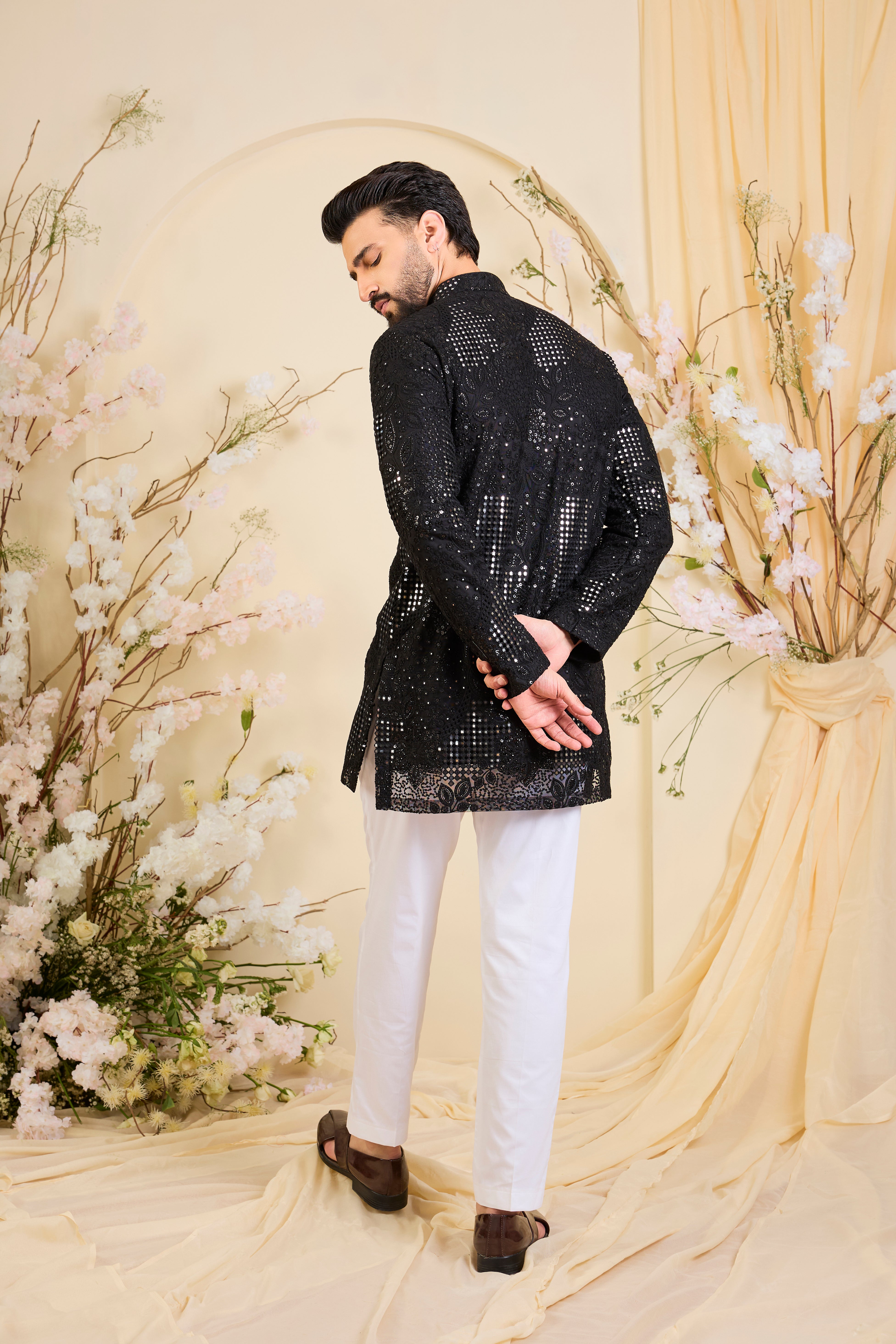 Black short kurta with sequin mirrorwork and delicate floral embroidery, offering a refined, luminous, and effortlessly sophisticated statement.